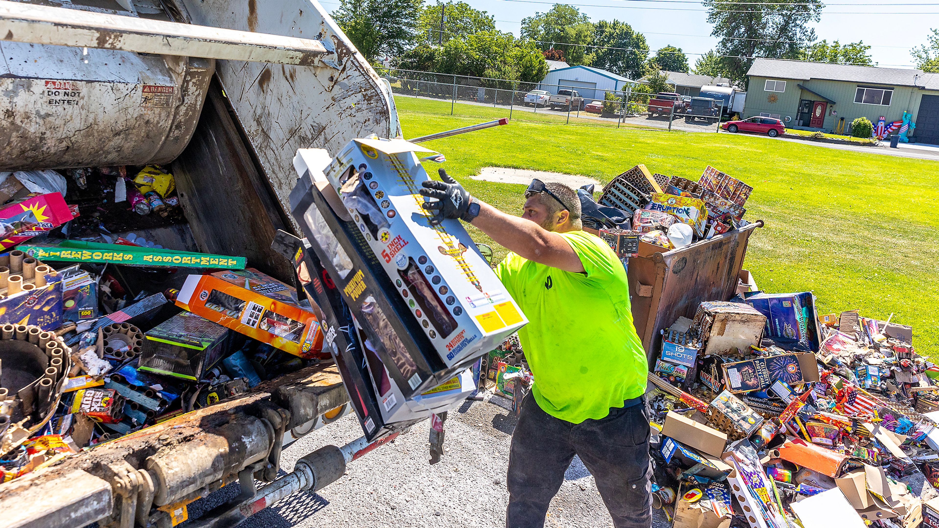 Trevor Charlo, with Naslund Disposal, cleans up firework debris left at the fields behind Lincoln Middle School Friday in Clarkston. Bill Horton and Kris Dugger arrived early in the morning and cleaned up and put much of the leftover debris into piles.