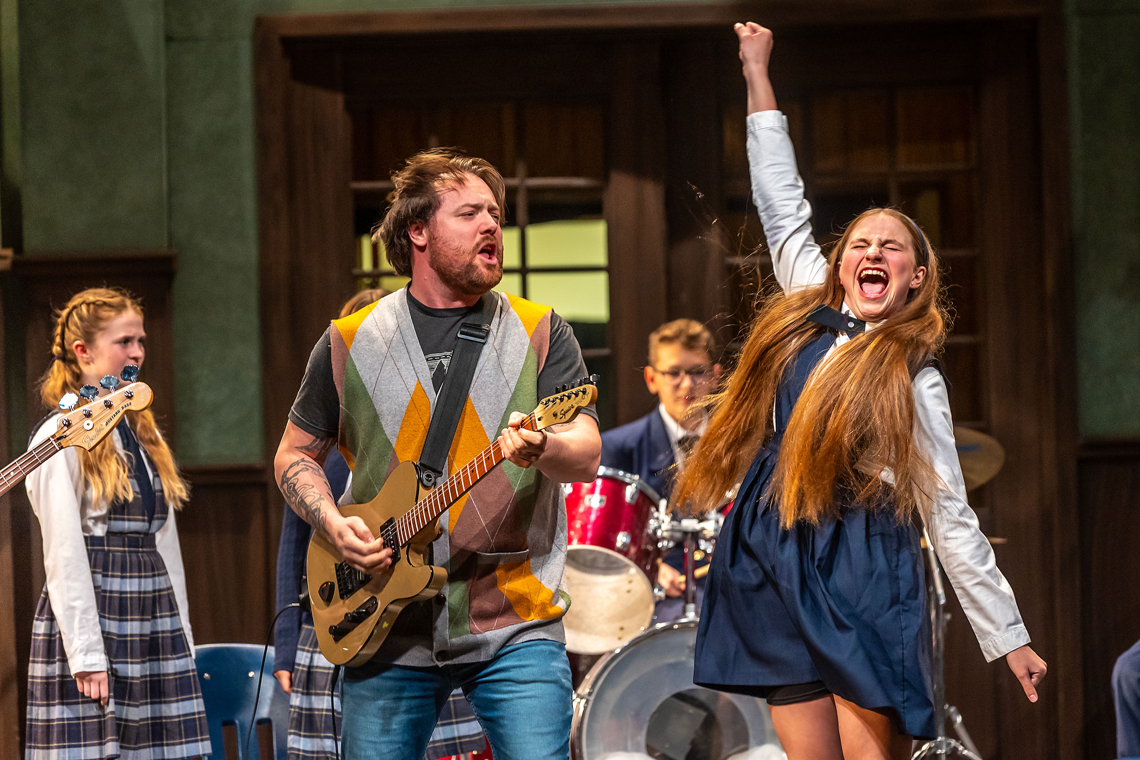 TJ Richardson, left, plays Dewey Finn, as Lila Heinzerling plays summer in the rockstar cast during a rehearsal for the Civic Theatre production of School of Rock Tuesday, May 21, in Lewiston.