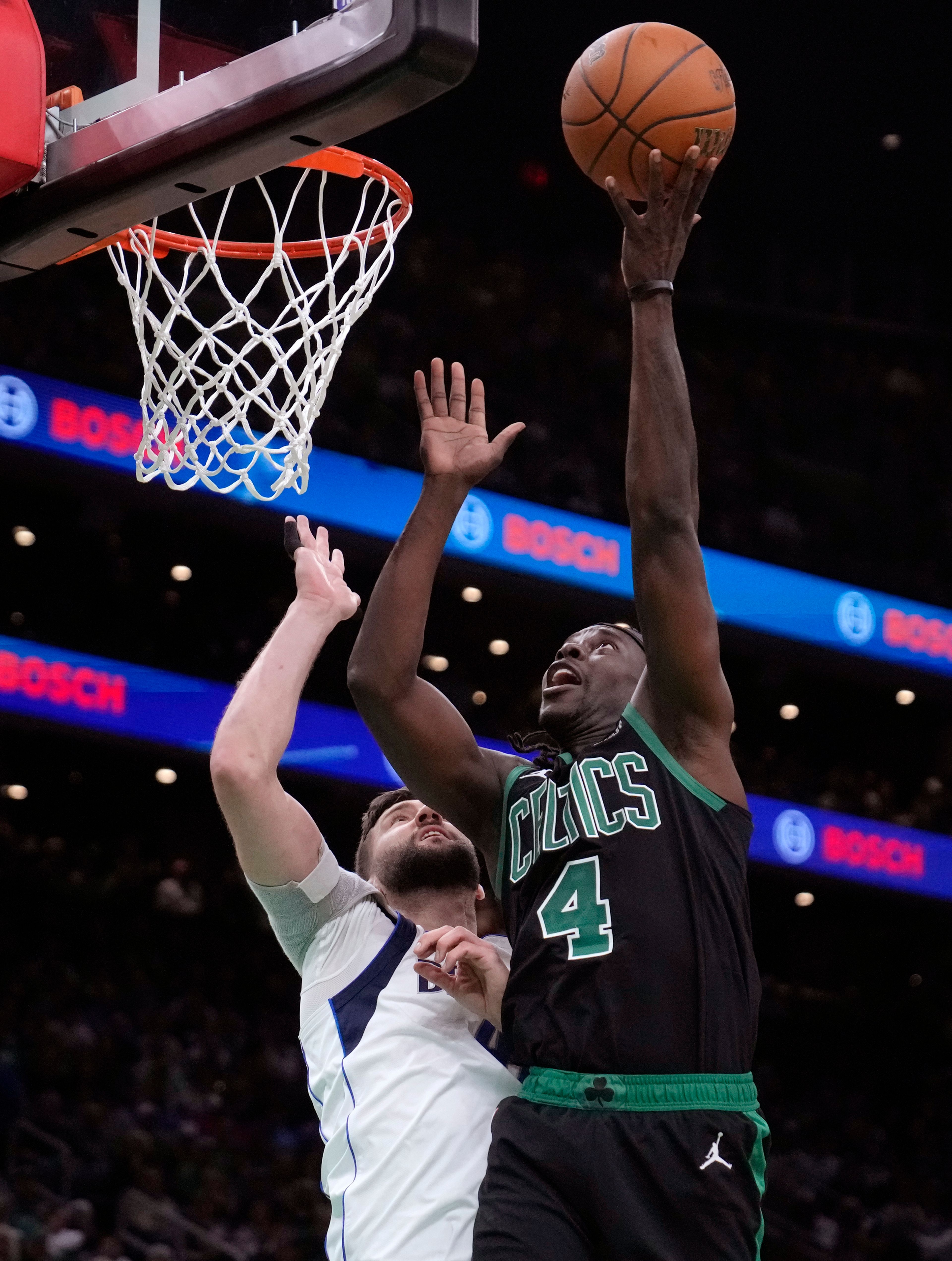 Boston Celtics guard Jrue Holiday shoots over Dallas Mavericks forward Maxi Kleber (42) during the first half of Game 2 of the NBA Finals basketball series, Sunday, June 9, 2024, in Boston.