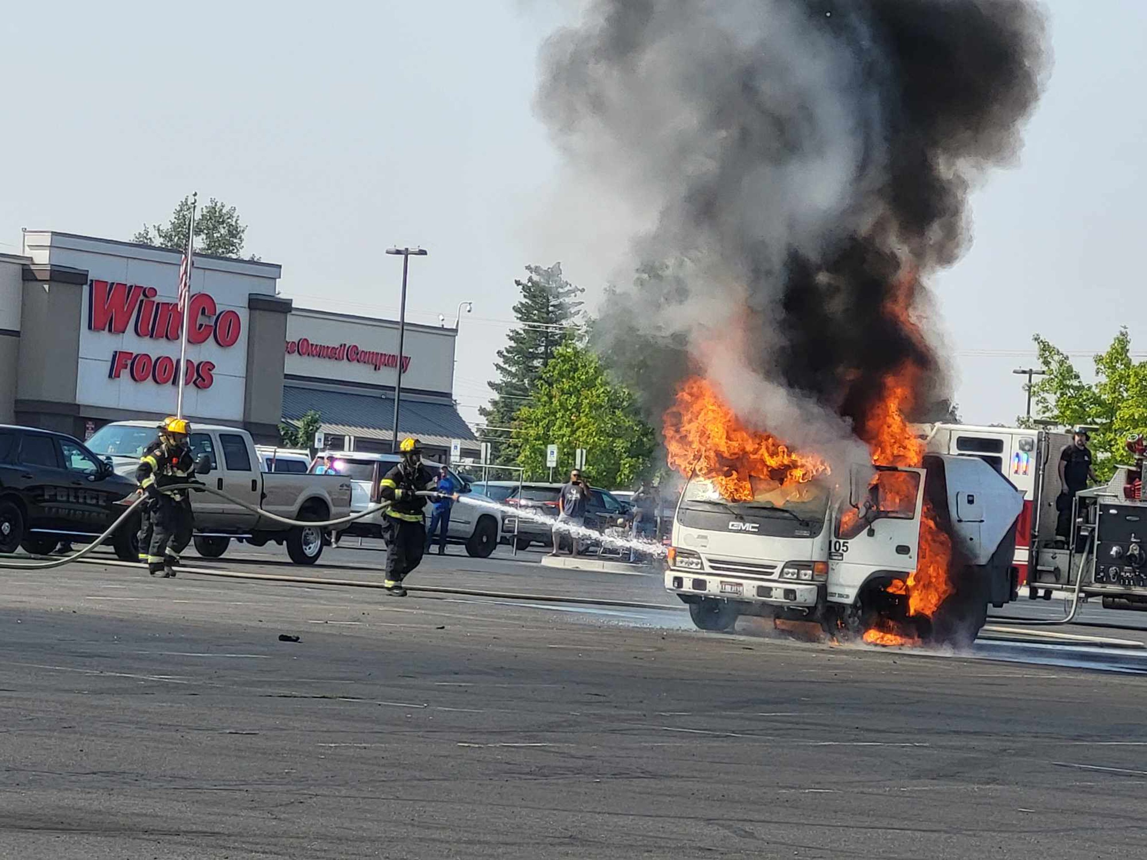 Firefighters work to put out a vehicle fire at the Lewiston Center Mall on Saturday morning.