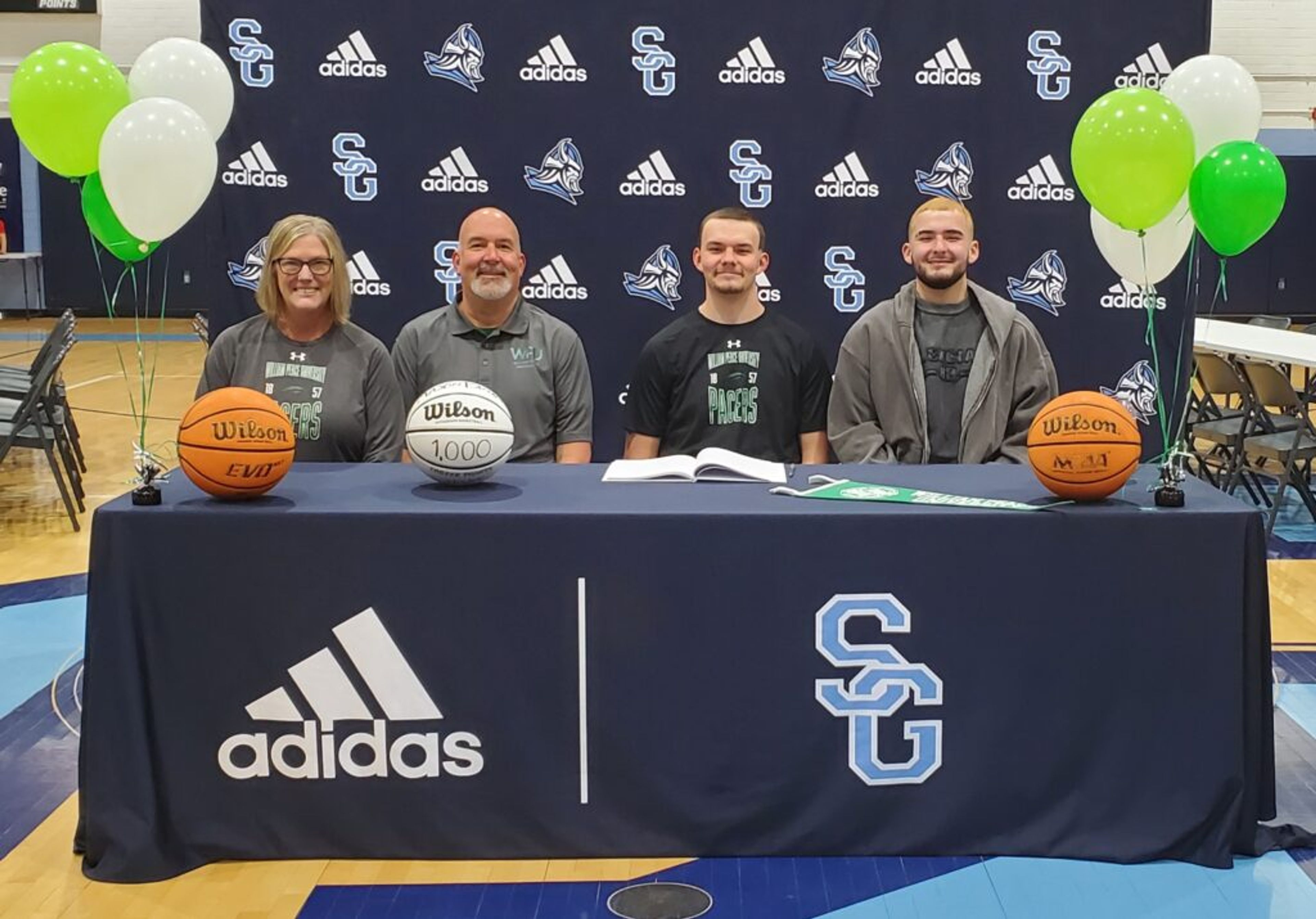 Brown signs with William Peace University - home hero image