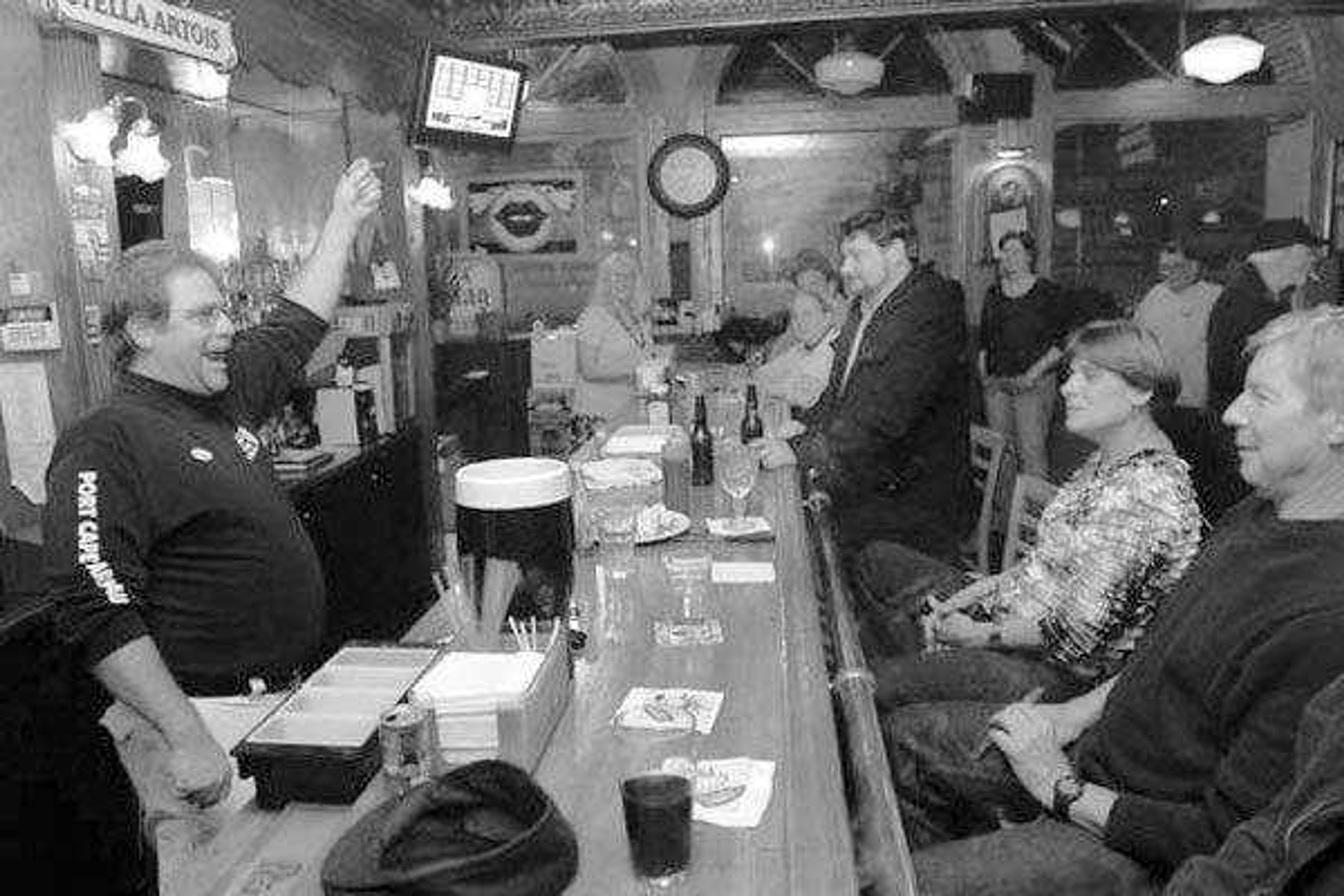 Kristin Eberts photo, SEMO News - Doc Cain, left, owner of Port Cape Girardeau and member of "Stand Up Cape, What's Next?", congratulates the crowd in his bar after unofficial results came in showing the smoking ban question was defeated 3,997 to 3,672, or 52.12 percent to 47.88 percent, on Tuesday, April 5, 2011.