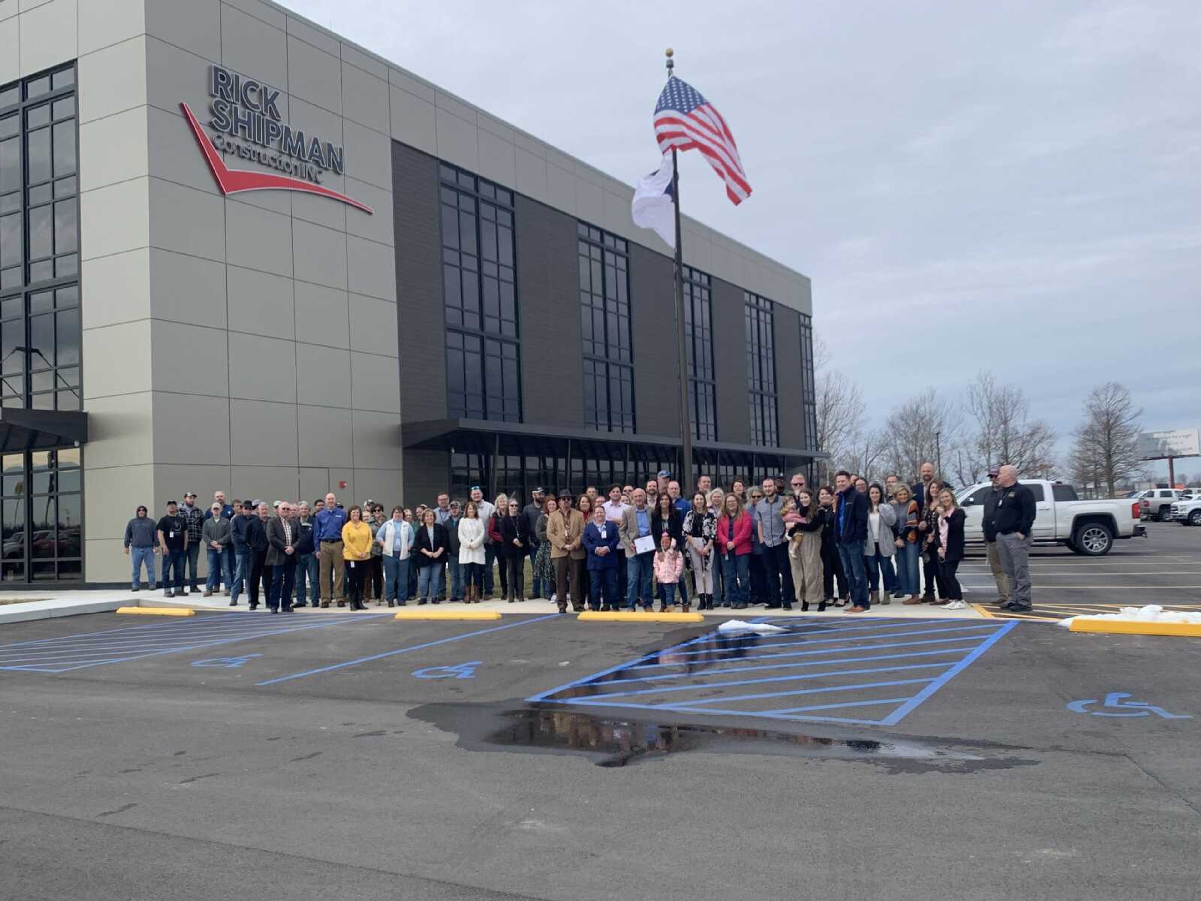 Employees and guests of Rick Shipman Construction gather for a photo following the dedication ceremony.
