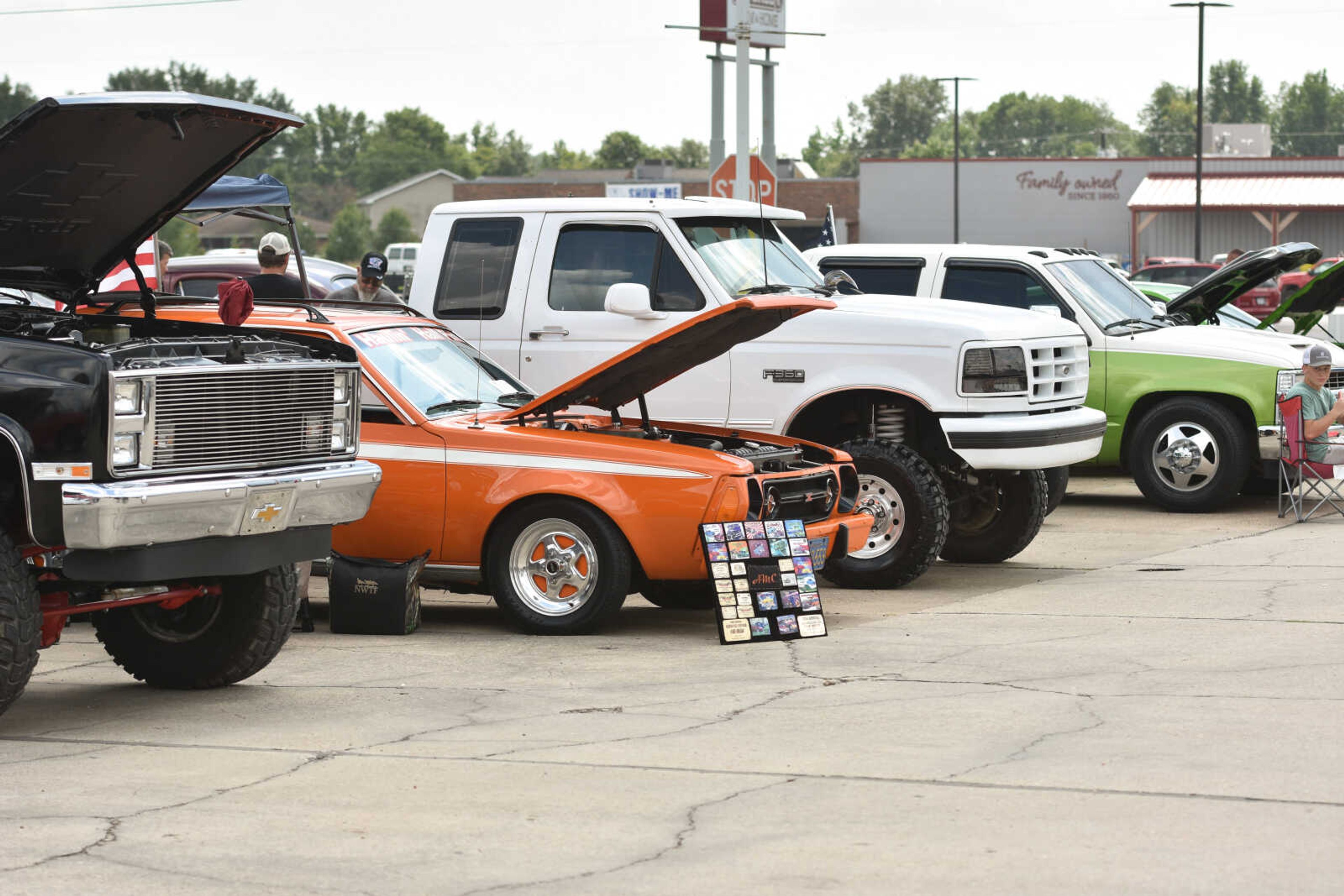 Attendees of the car show view one of the vehicles brought to participate in the festivities.