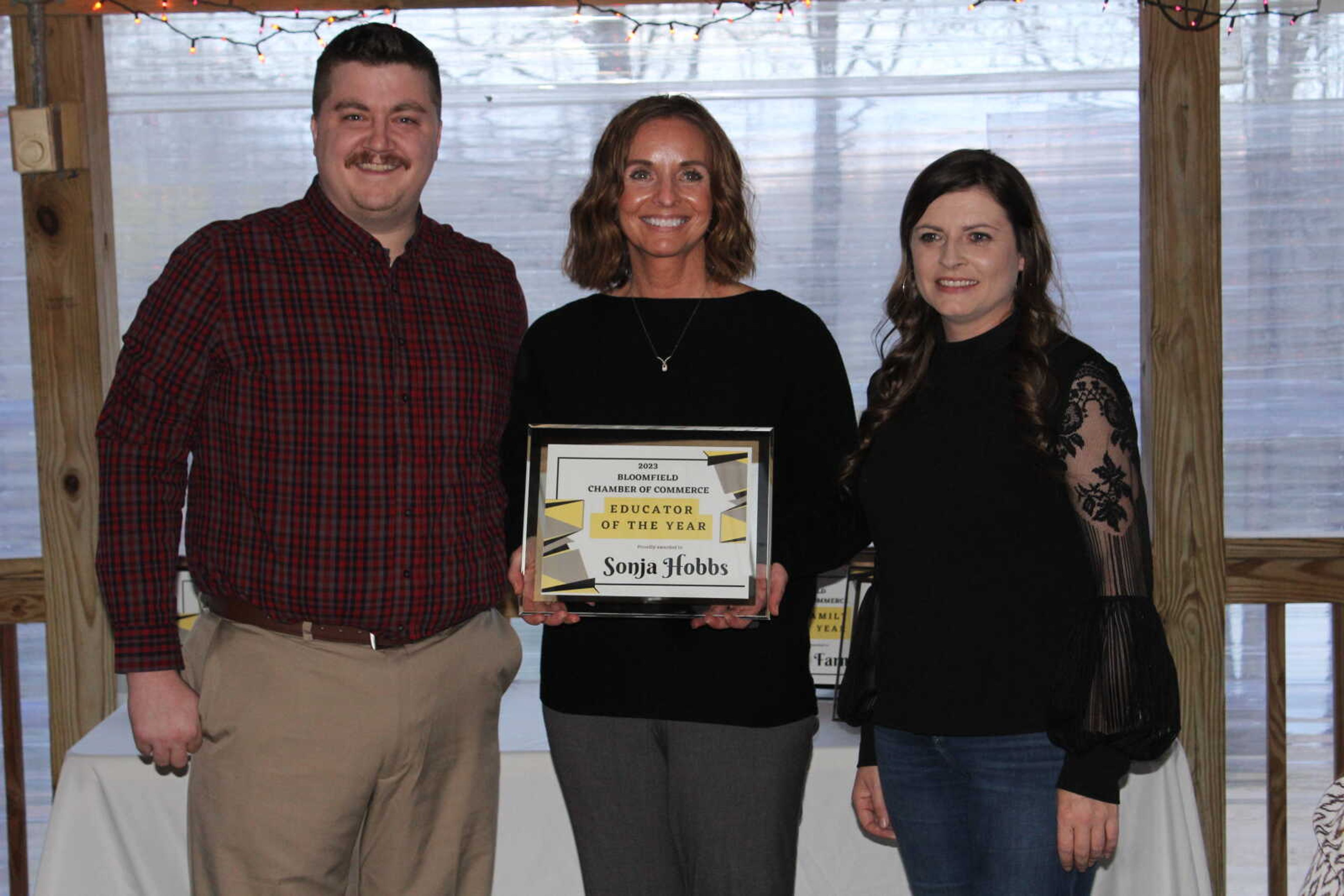 The Teacher of the Year Award was presented to Sonja Hobbs. Hobbs has taught at Bloomfield for 23 years and a member of the staff for 25 years. Pictured is Bloomfield Chamber Board member Zach Pounds, Hobbs and Chamber president Amy Haas.