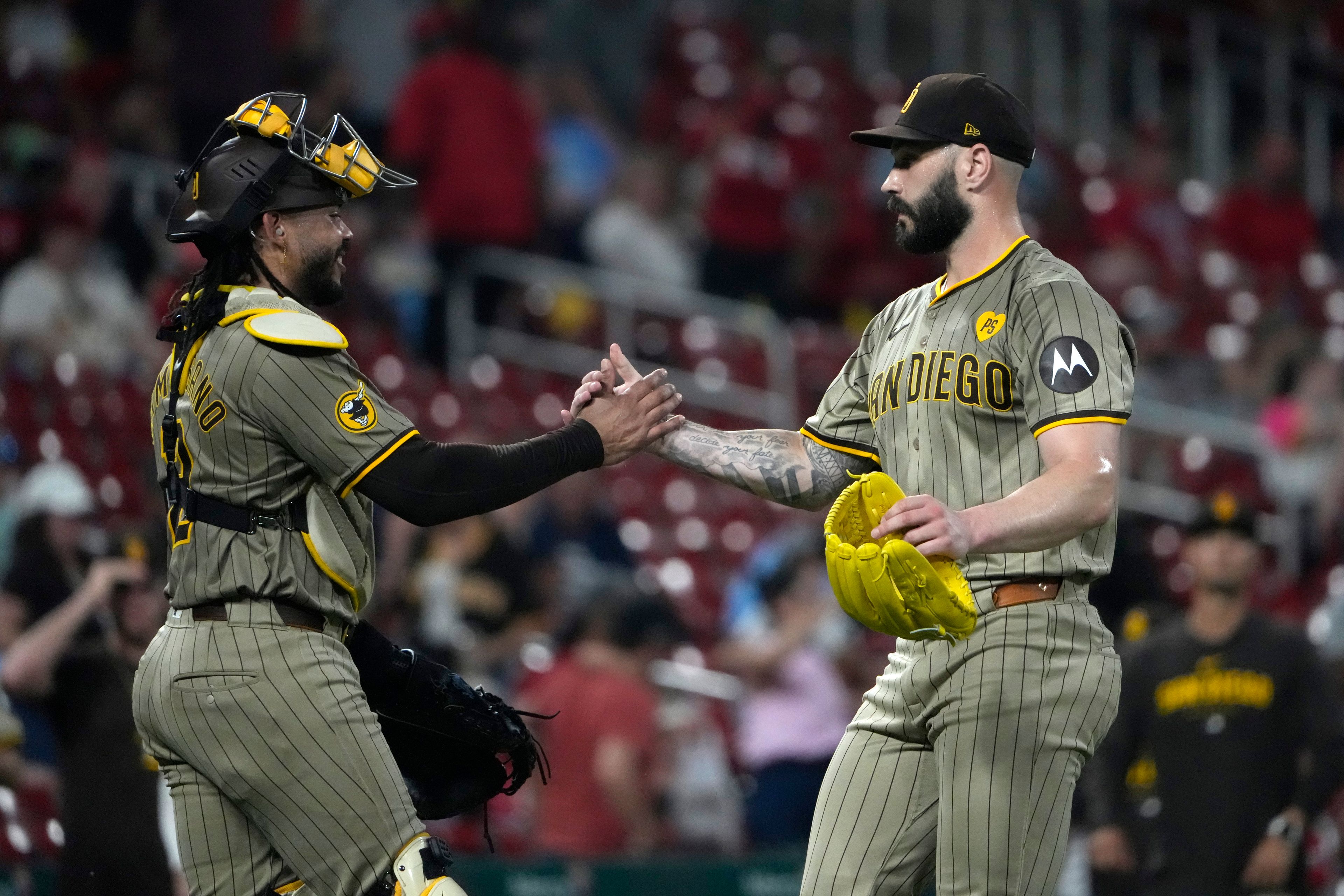 San Diego Padres pitcher Tanner Scott celebrates with catcher Luis Campusano following a 7-5 victory over the St. Louis Cardinals in a baseball game Tuesday, Aug. 27, 2024, in St. Louis. (AP Photo/Jeff Roberson)