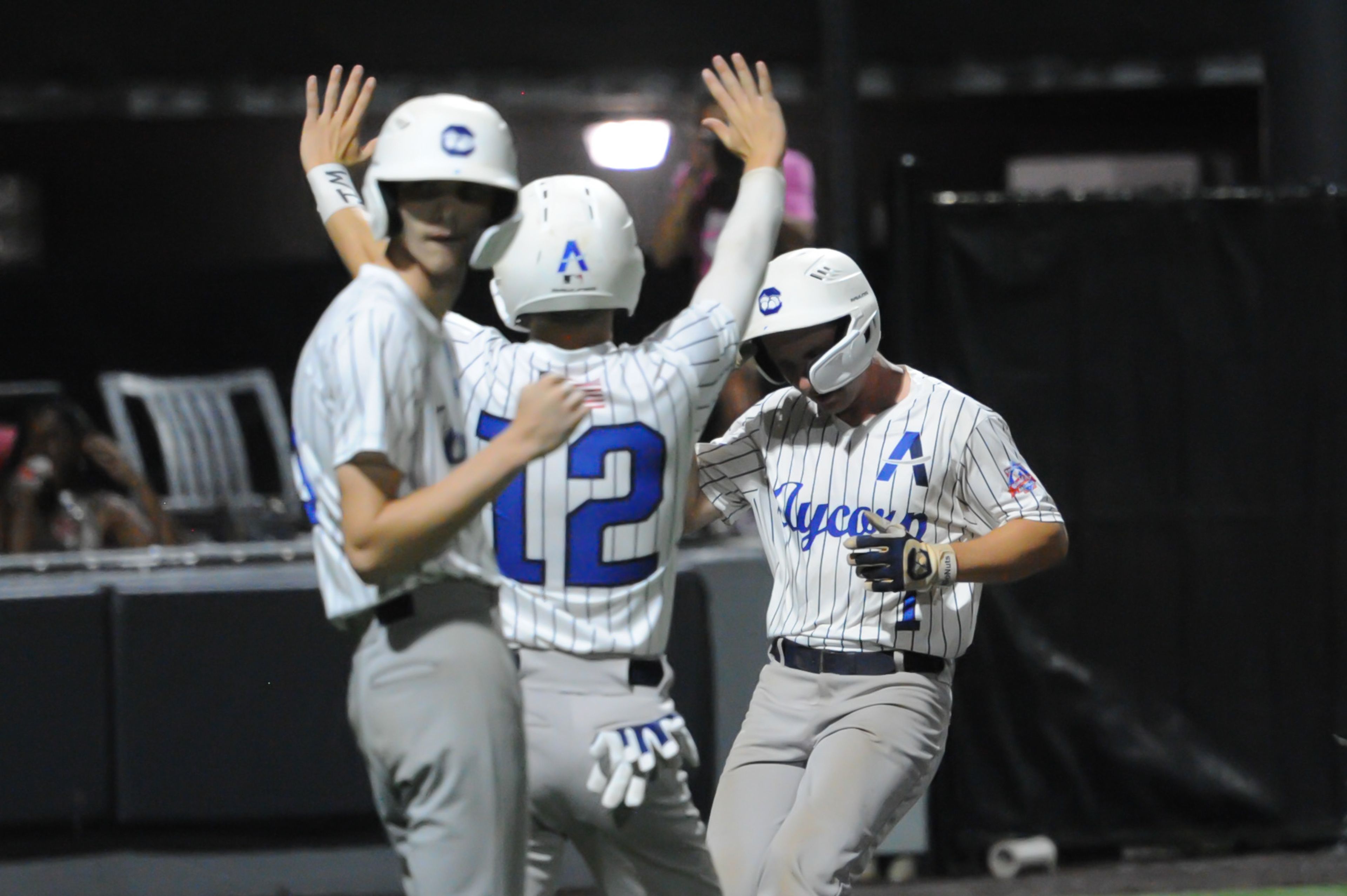 Aycorp's Will Green (center) greets Owen Osborne (right) after Osborne converted a single into a Little-League homer during a Tuesday, August 13, 2024 Babe Ruth World Series game between the Aycorp Fighting Squirrels and Holland Henson of the Netherlands at Capaha Field in Cape Girardeau, Mo. Aycorp defeated the Netherlands, 12-2 in five innings.