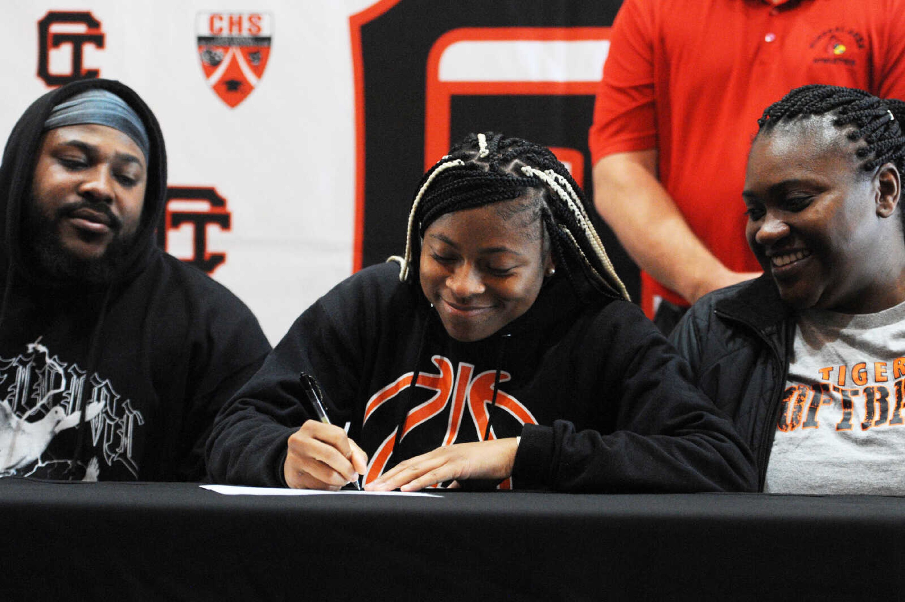 Cape Central's Ki Bogan signs a letter of intent to play softball at Mineral Area College on Thursday at Cape Central High School.