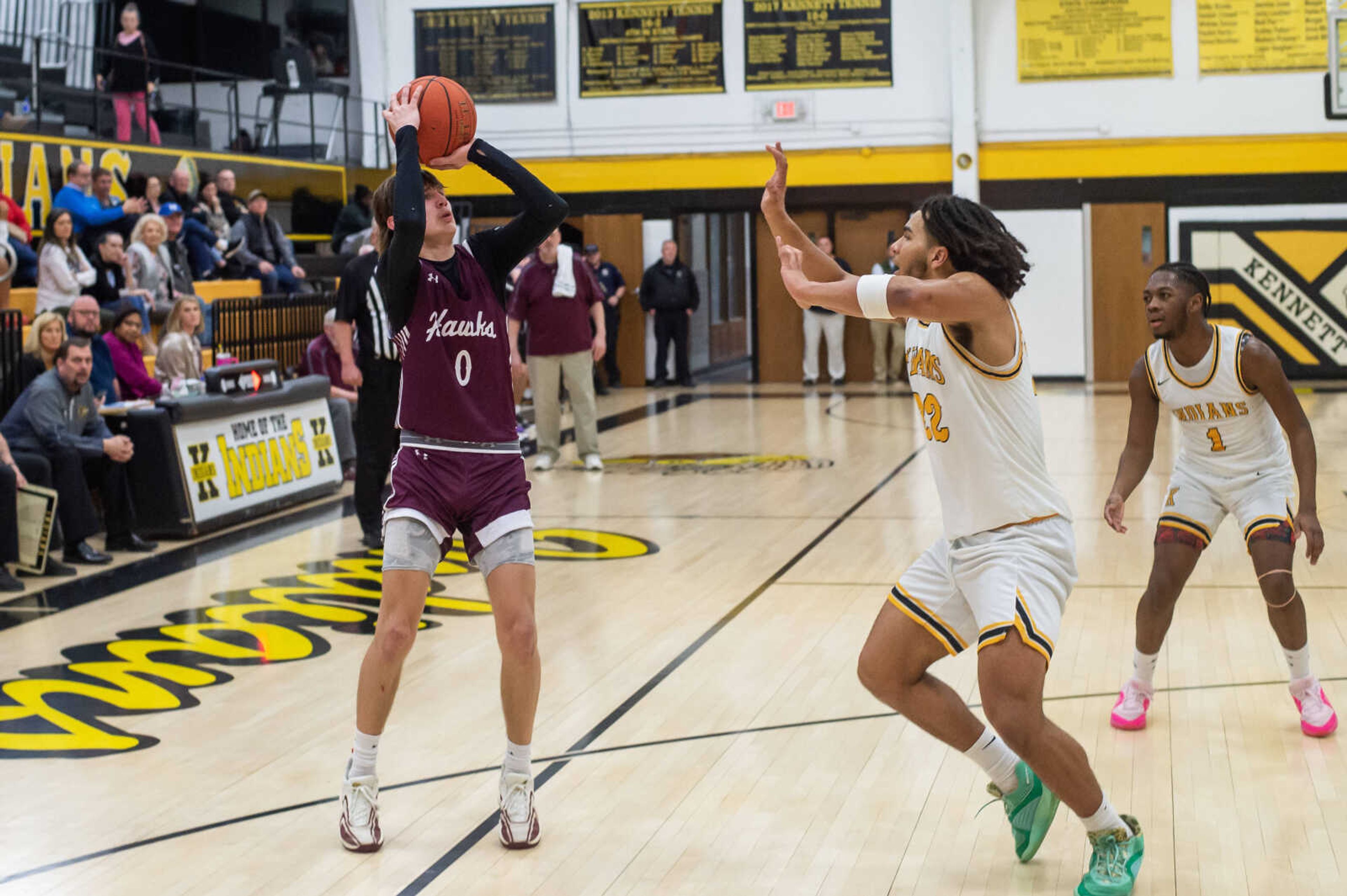 Kelly's Ross Peters, guarded by Kennett's Chris Jefferson, fires off a shot in a game at Kennett Tuesday, Feb. 13. 