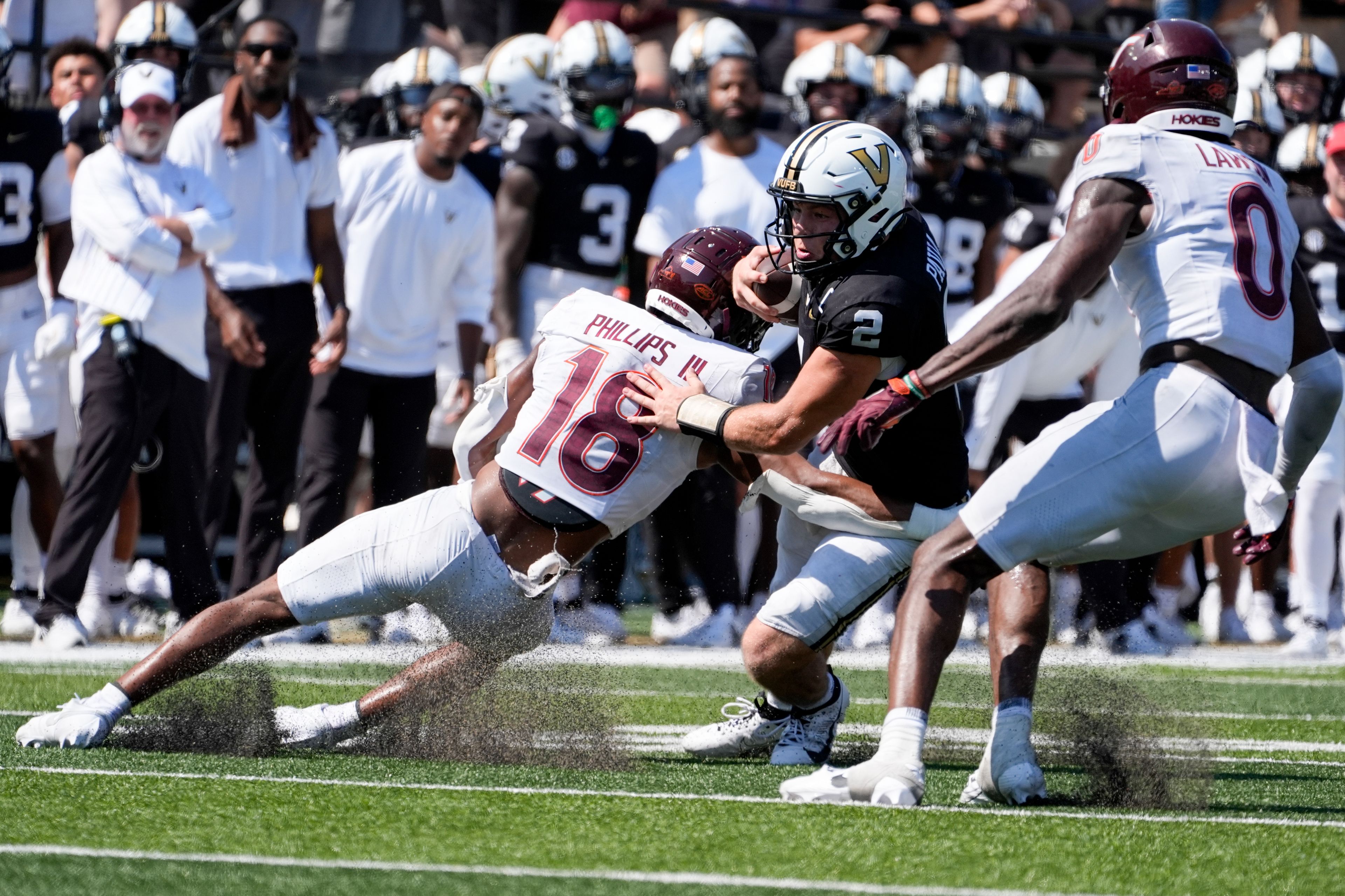 Vanderbilt quarterback Diego Pavia (2) runs the ball against Virginia Tech safety Mose Phillips III (18) and linebacker Keli Lawson (0) during overtime of an NCAA college football game Saturday, Aug. 31, 2024, in Nashville, Tenn. (AP Photo/George Walker IV)