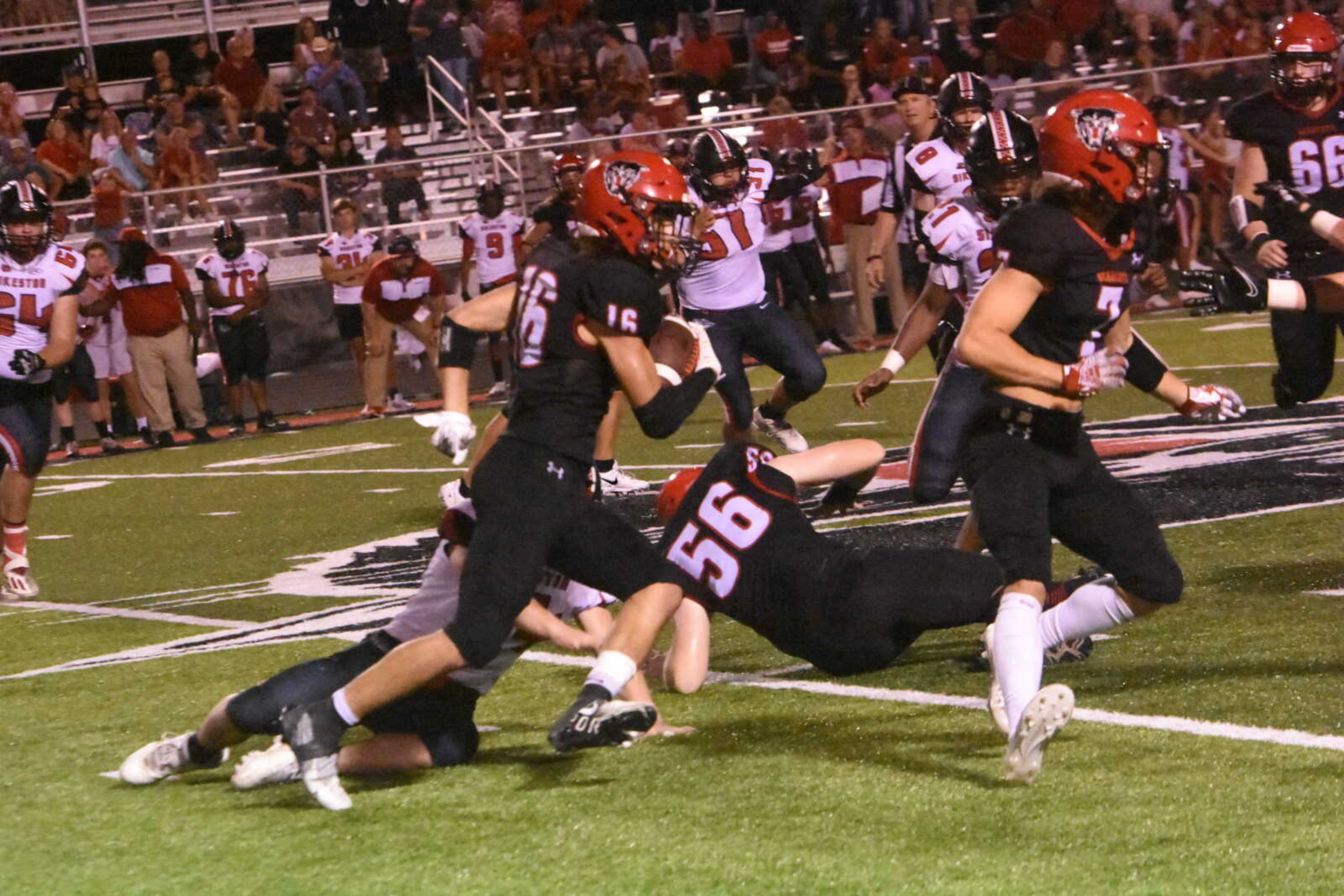 Dexter's Juan Cuevas (16) tries to elude a Sikeston defender.