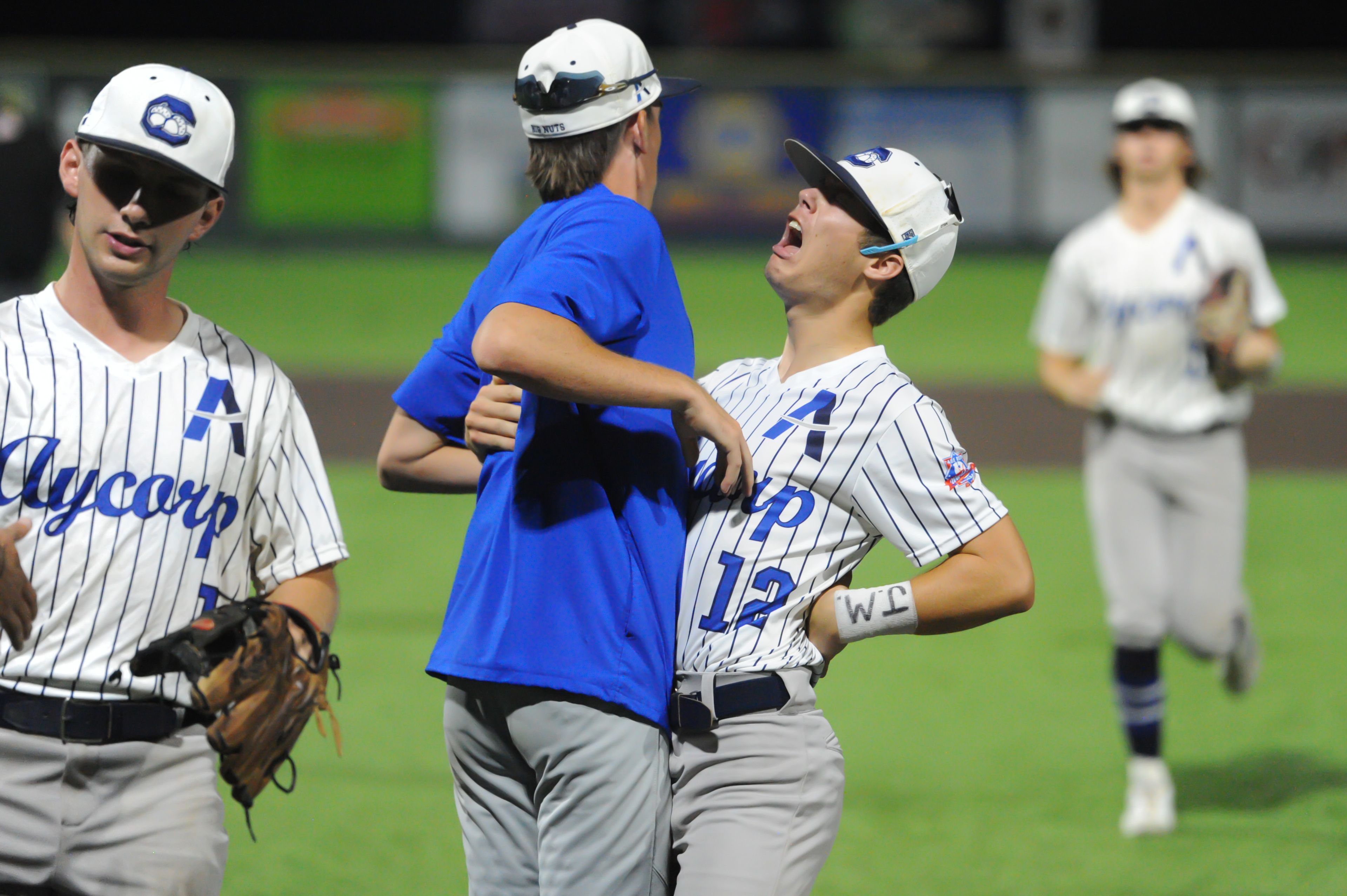 Aycorp's Brady Smith (center) celebrates with teammate Will Green (right) following a Tuesday, August 13, 2024 Babe Ruth World Series game between the Aycorp Fighting Squirrels and Holland Henson of the Netherlands at Capaha Field in Cape Girardeau, Mo. Aycorp defeated the Netherlands, 12-2 in five innings.