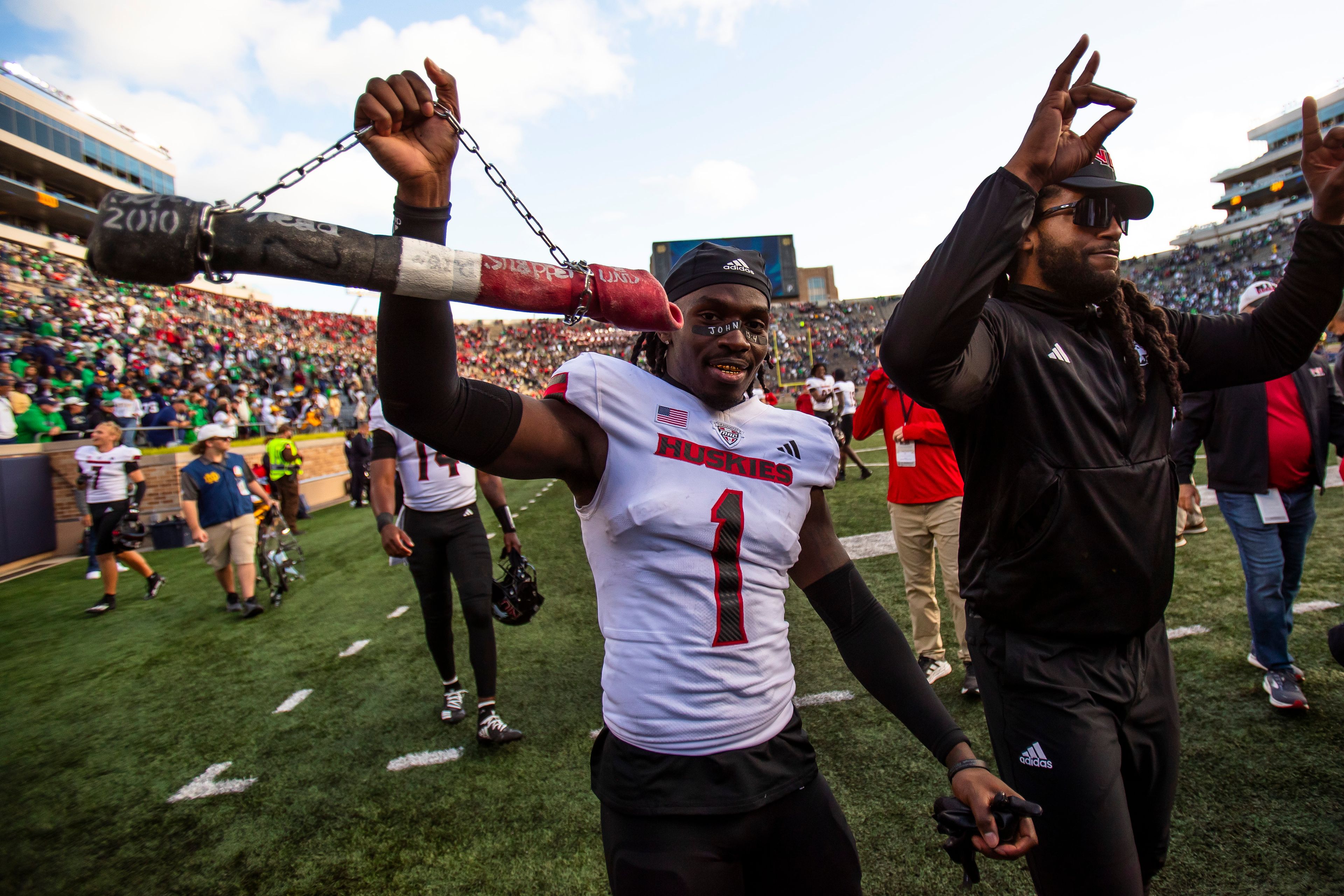 Northern Illinois defensive back Jashon Prophete (1) celebrates with a dog bone on a chain after defeating Notre Dame in an NCAA college football game Saturday Sept. 7, 2024, in South Bend, Ind. (AP Photo/Michael Caterina)