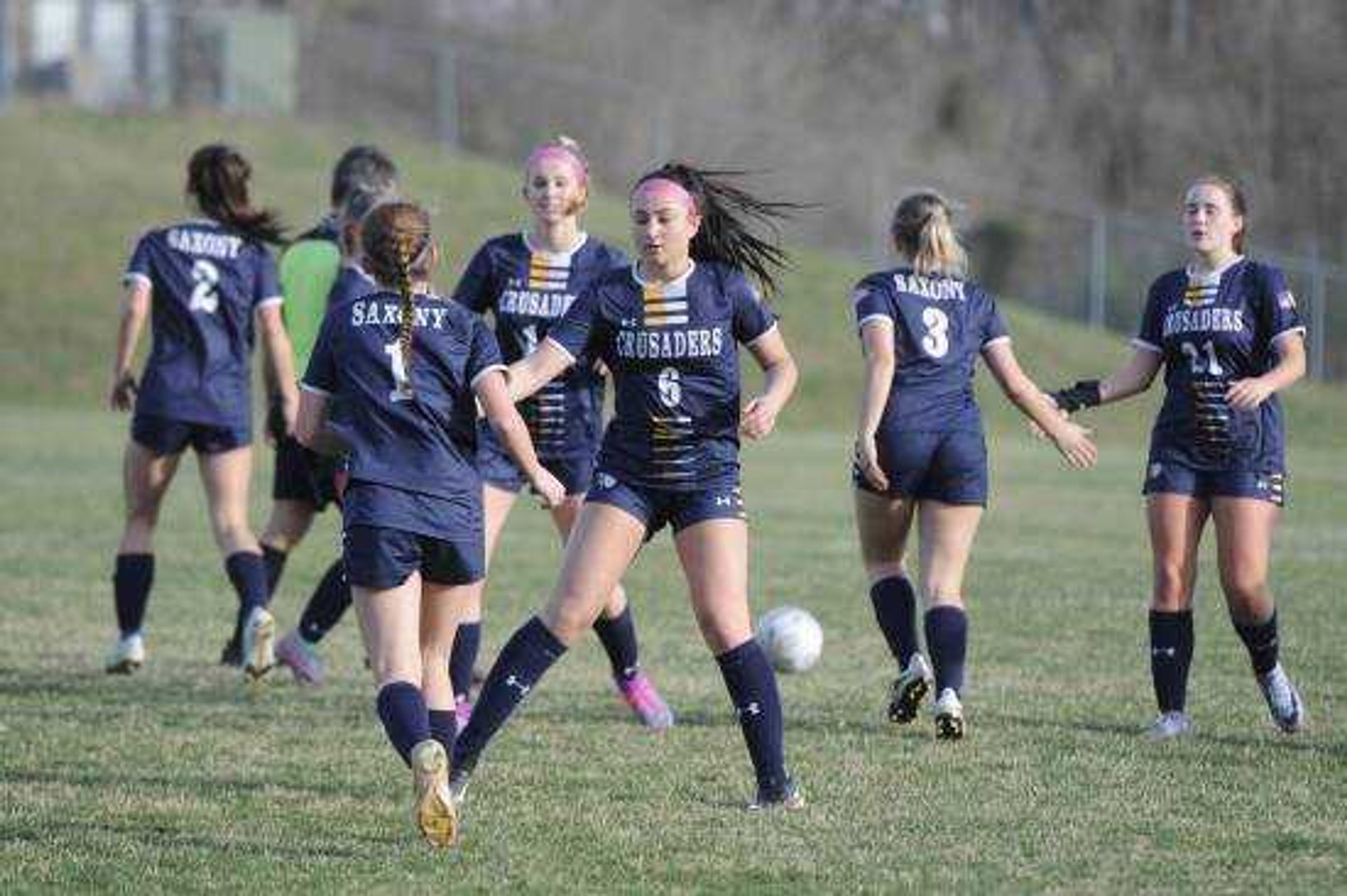 The Saxony Lutheran Crusaders celebrate after scoring a goal during a game this season.