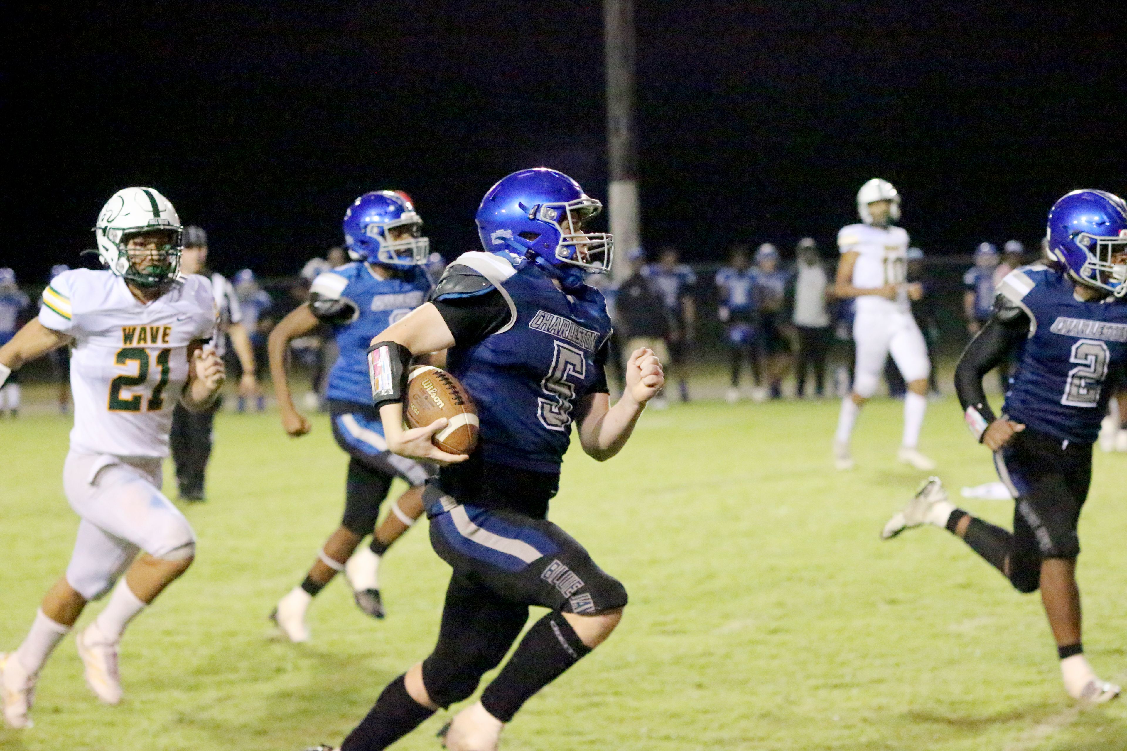 Charleston’s Kaden Branam (5) returns an interception for a touchdown during a 54-20 win over Malden on Friday, Sep. 13.