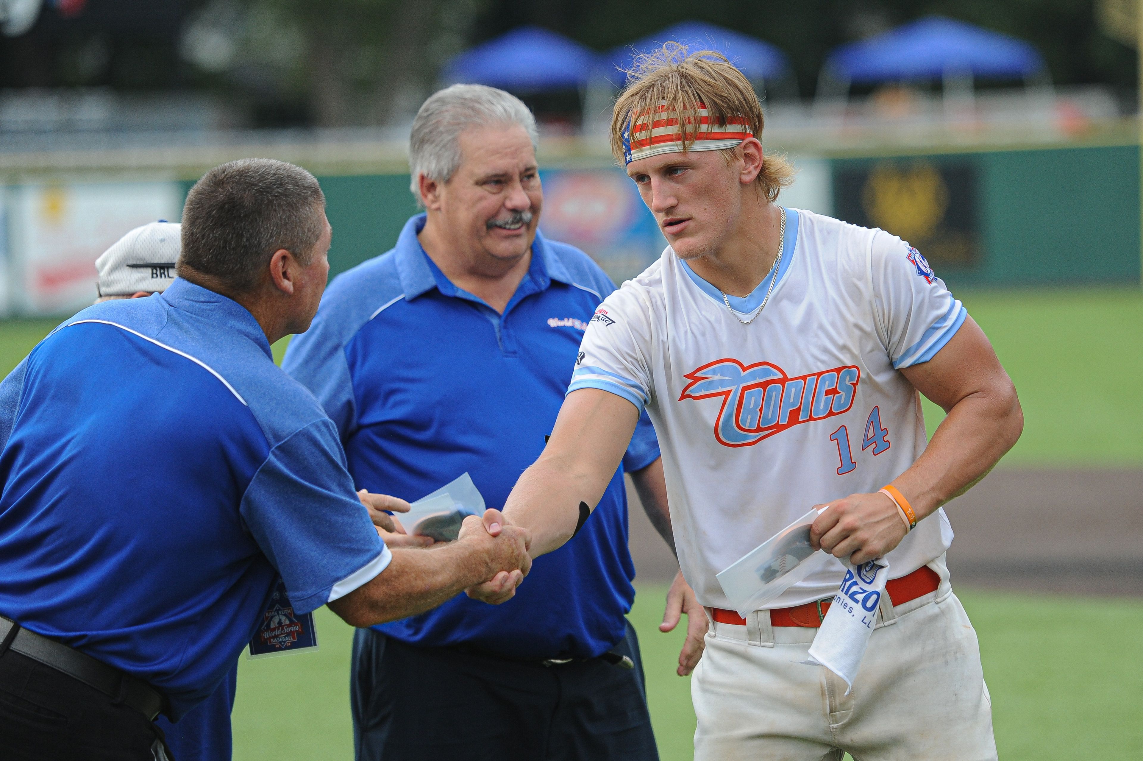 Southeast's Trey Benthal (right) receives his bronze medal following the August 15, 2024 Babe Ruth World Series third-place game between the Charleston Fighting Squirrels and the Southeast Tropics at Capaha Field in Cape Girardeau, Mo. Southeast defeated Charleston, 11-2 in five innings.