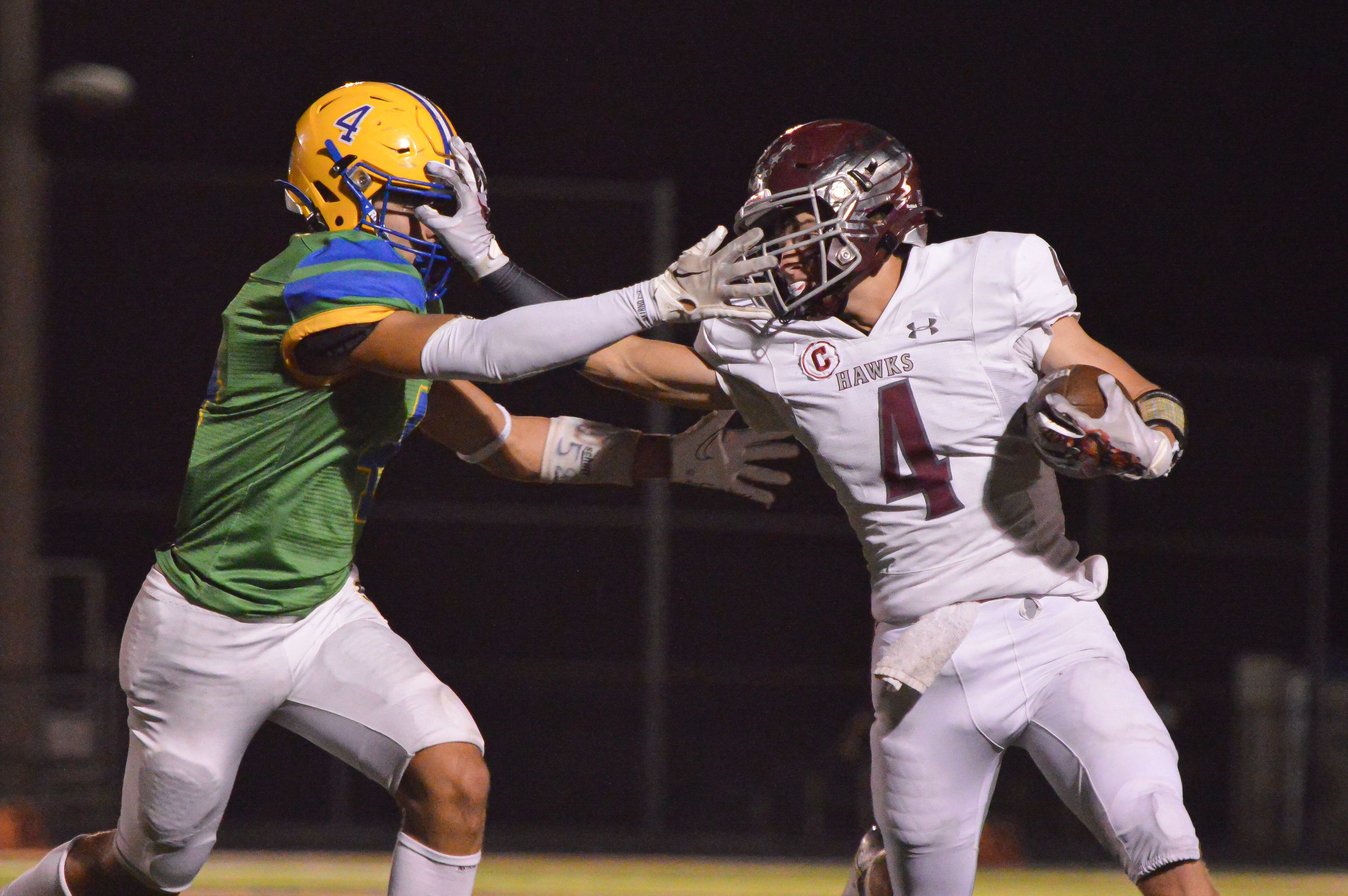 Kelly running back Ryder Krauss stiff arms a Scott City defender in the rivalry game on Friday, Sept. 6.