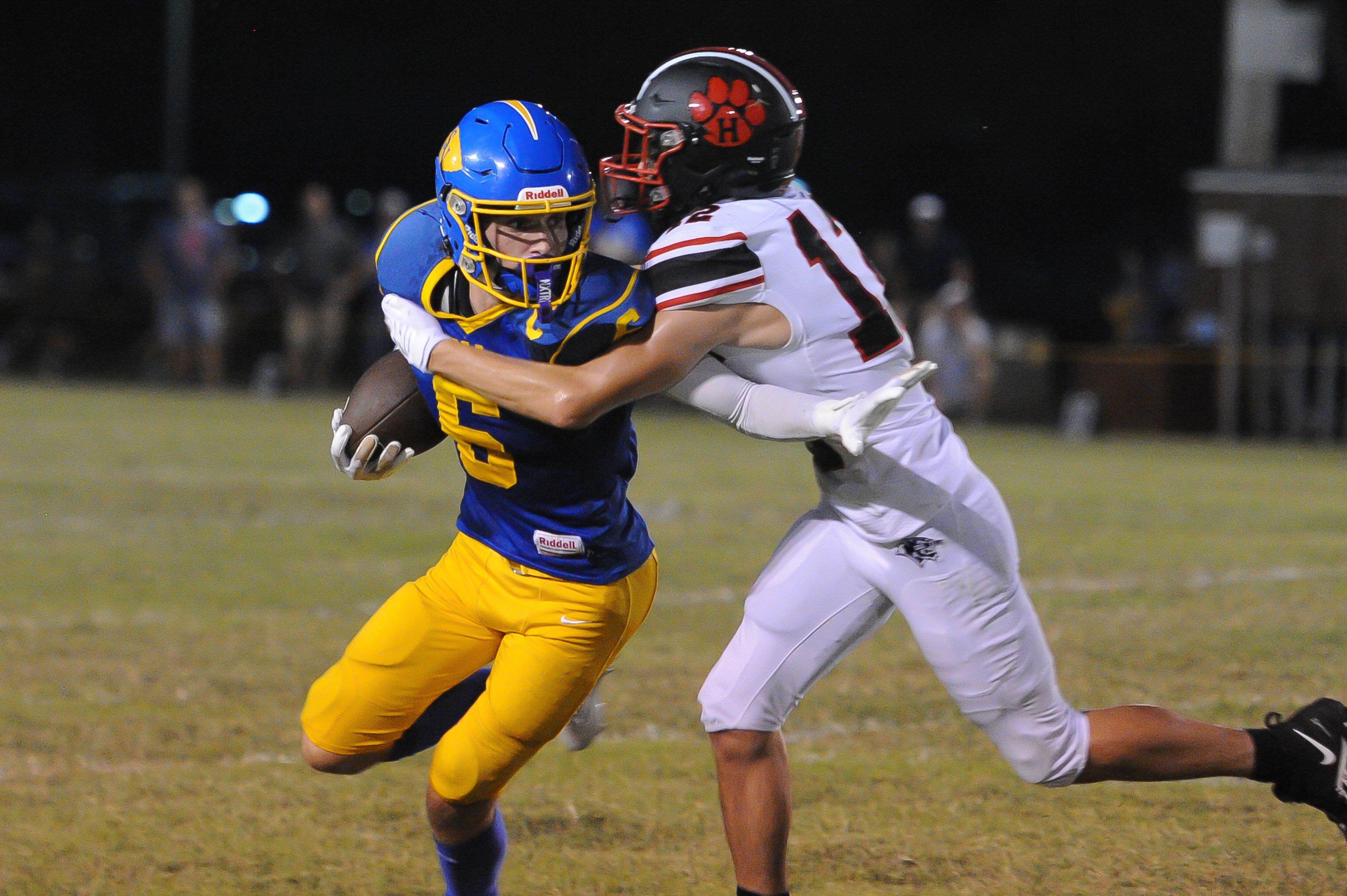 St. Vincent's Clayton Gremaud (left) attempts to stiff a defender during a Friday, September 20, 2024 game between the St. Vincent Indians and the Herculaneum Blackcats at St. Vincent High School in Perryville, Mo. St. Vincent defeated Herculaneum, 47-7.