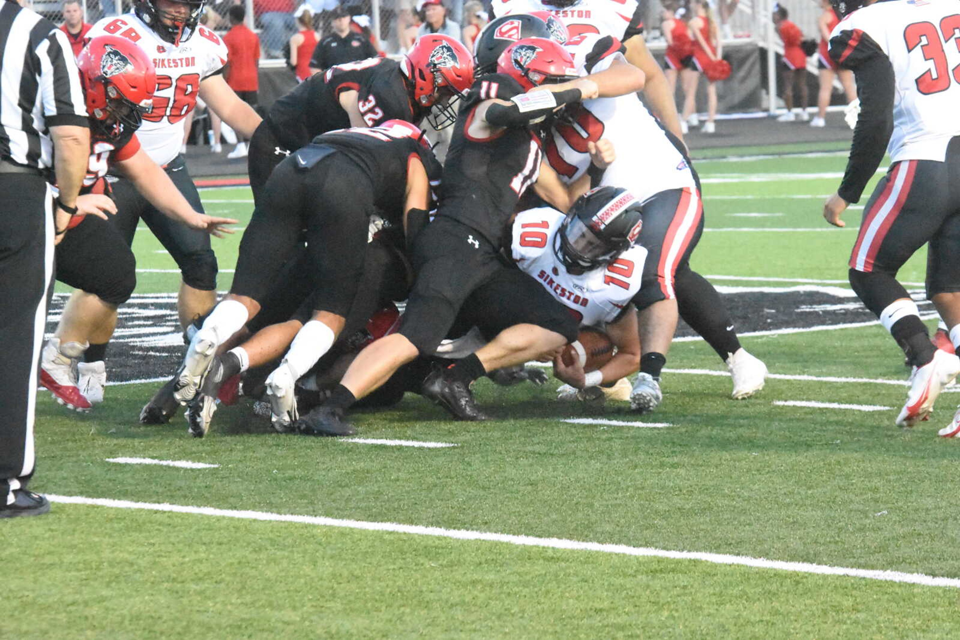 The Dexter defense stops Sikeston quarterback Joseph Heckemeyer.