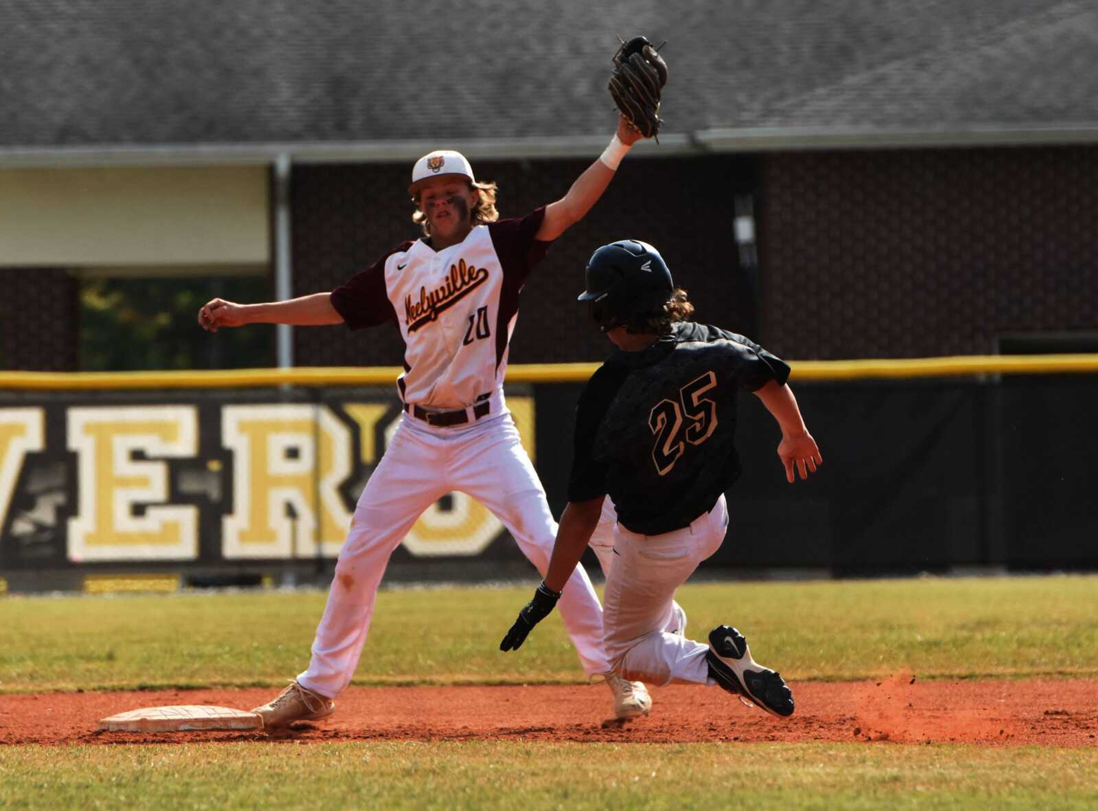 Doniphan's Blake Lewis slides into second while Neelyville shortstop Bryce Dollins reels in the throw down during the first round of the OFC Tournament on Monday, Oct. 10, 2022 in Poplar Bluff.