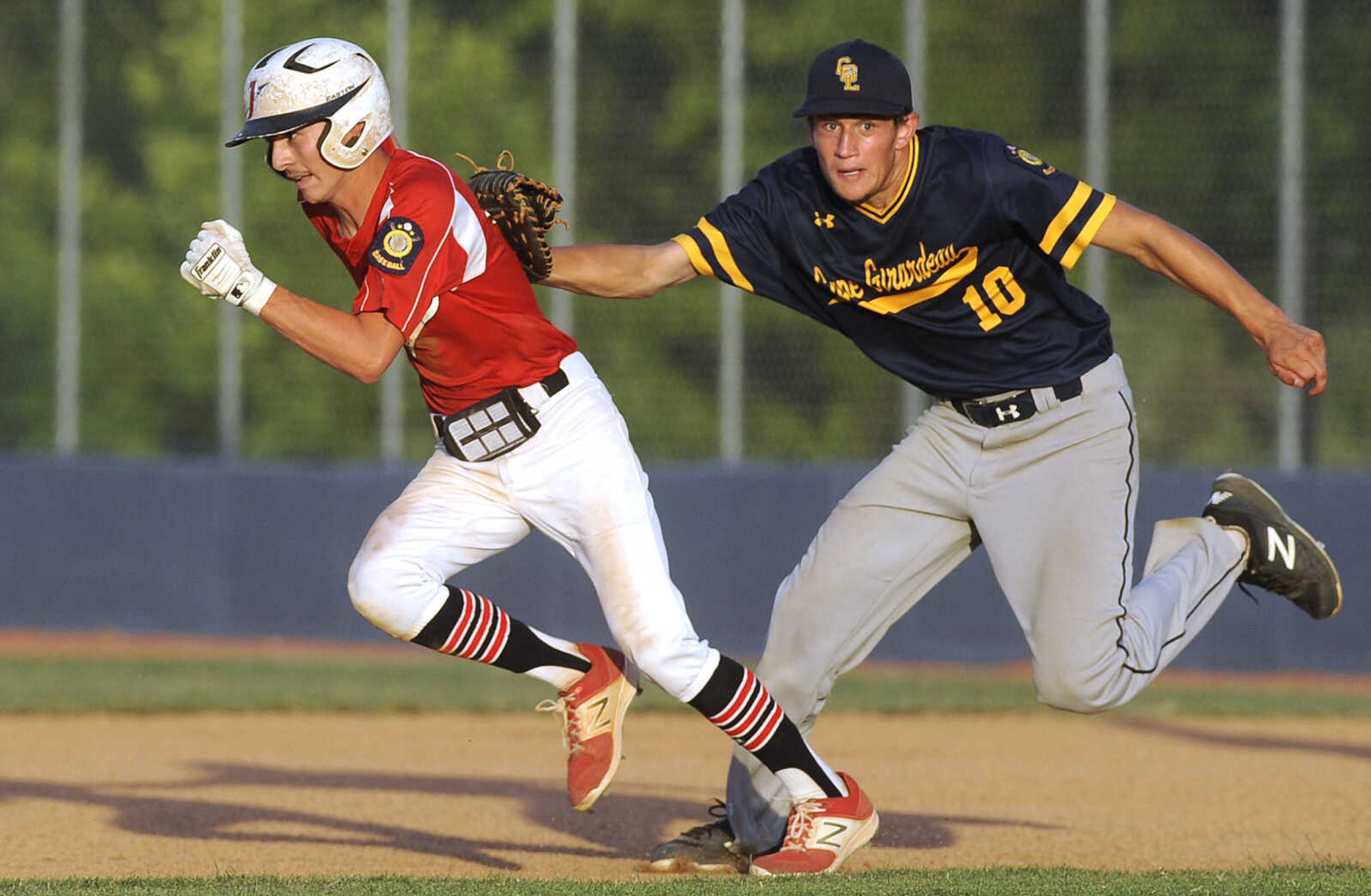 FRED LYNCH ~ flynch@semissourian.com
Jackson Senior Legion's Drew Brown tries to escape the tag by Cape Girardeau Post 63 first baseman Cooper Crosnoe in a rundown during the fifth inning Thursday, June 7, 2018 in Jackson.