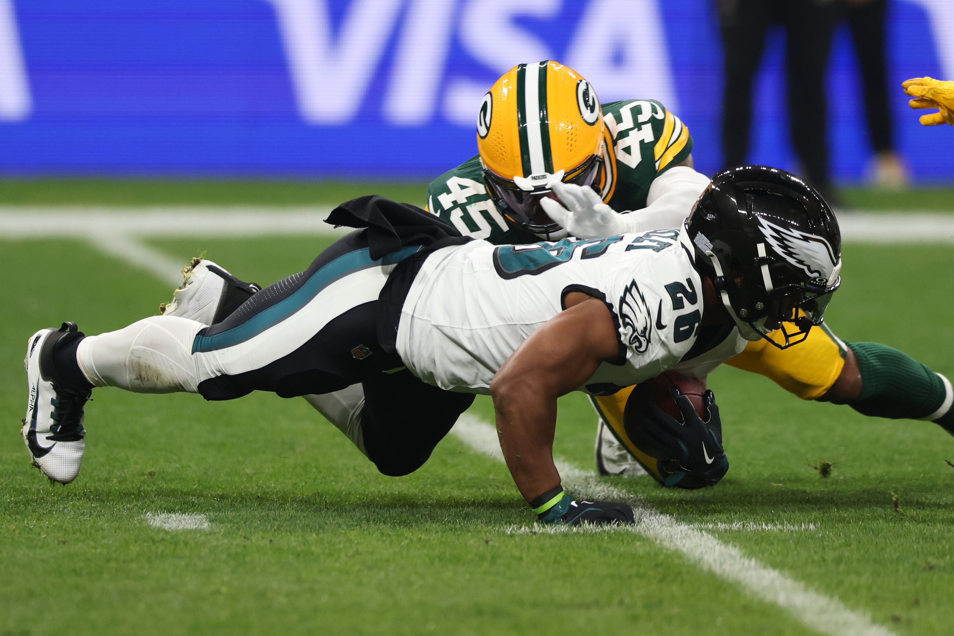 Philadelphia Eagles running back Saquon Barkley (26) is tackled by Green Bay Packers linebacker Eric Wilson (45) during the first half of an NFL football game, Friday, Sept. 6, 2024, at the Neo Quimica Arena in Sao Paulo. (AP Photo/Gregory Payan)