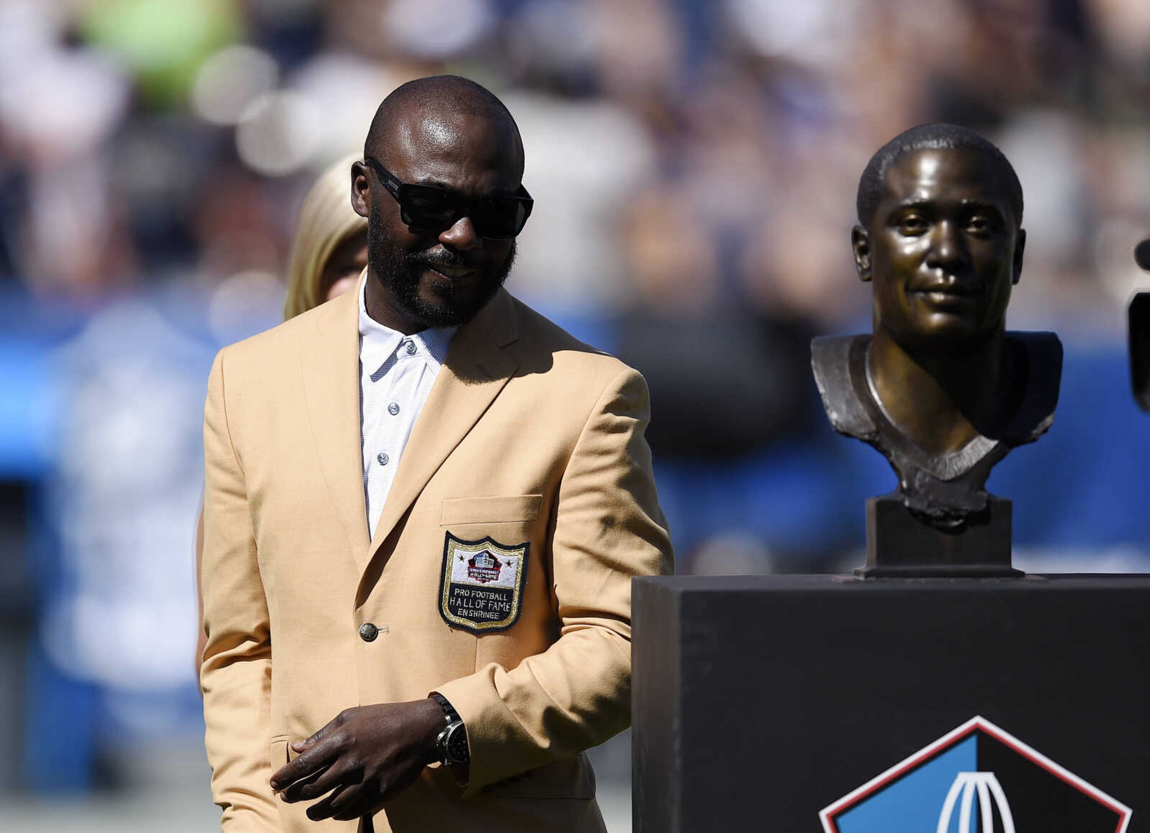 Former Rams team member Marshall Faulk looks at his bust during the Rams Hall of Fame Ring of Excellence ceremony on Sunday, Sept. 18, 2016, in Los Angeles.