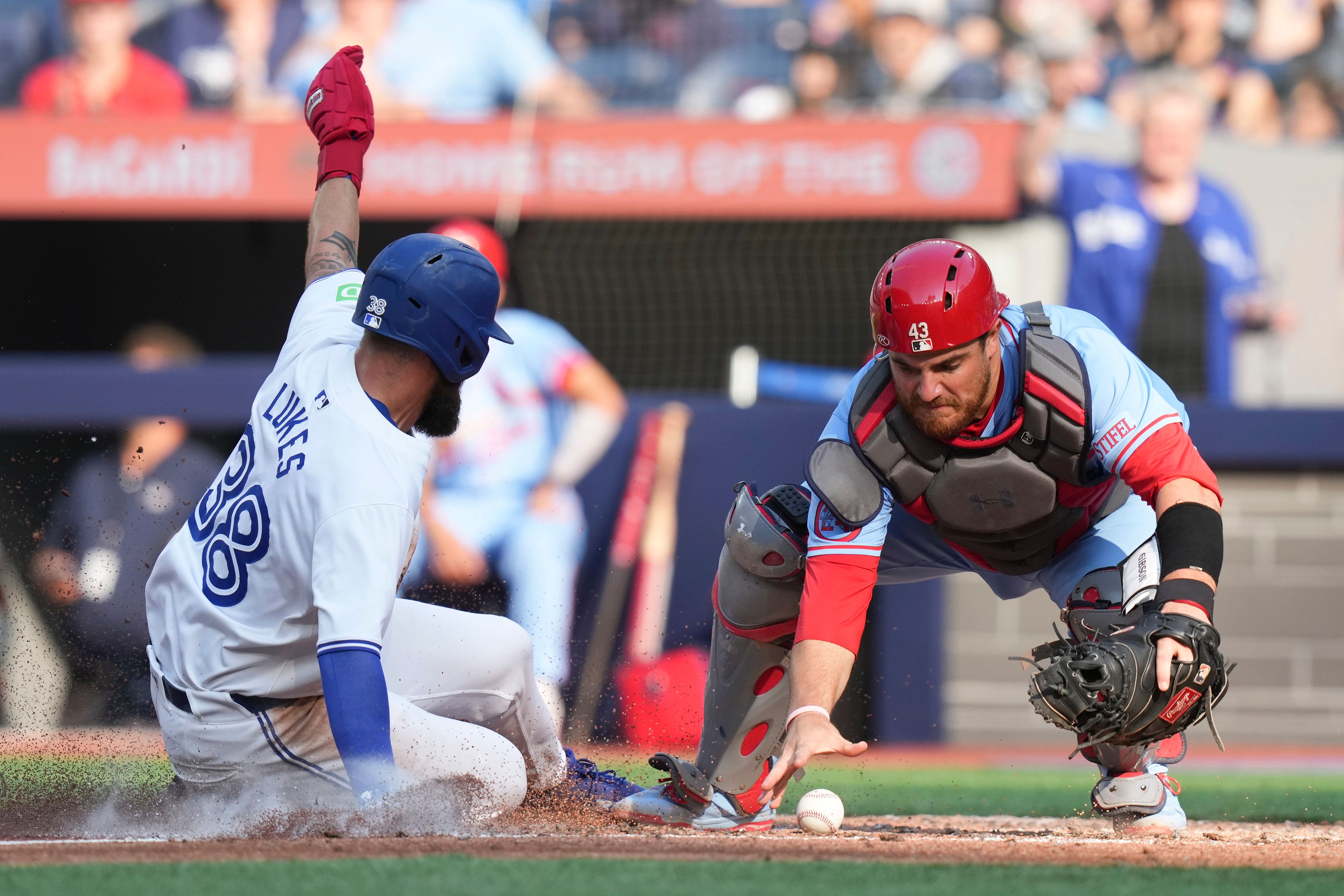 St. Louis Cardinals catcher Pedro Pages reaches for the ball as Toronto Blue Jays' Nathan Lukes scores during sixth inning interleague MLB baseball action in Toronto, Saturday, September 14, 2024. (Chris Young/The Canadian Press via AP)