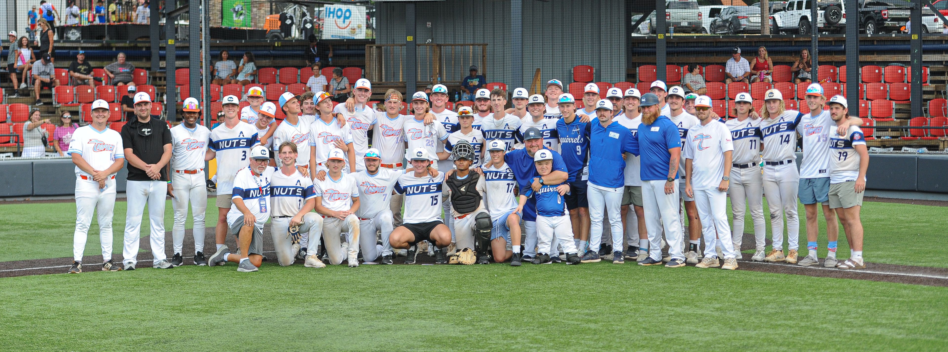 Charleston and Southeast players line up for a dual-team photo following the August 15, 2024 Babe Ruth World Series third-place game between the Charleston Fighting Squirrels and the Southeast Tropics at Capaha Field in Cape Girardeau, Mo. Southeast defeated Charleston, 11-2 in five innings.