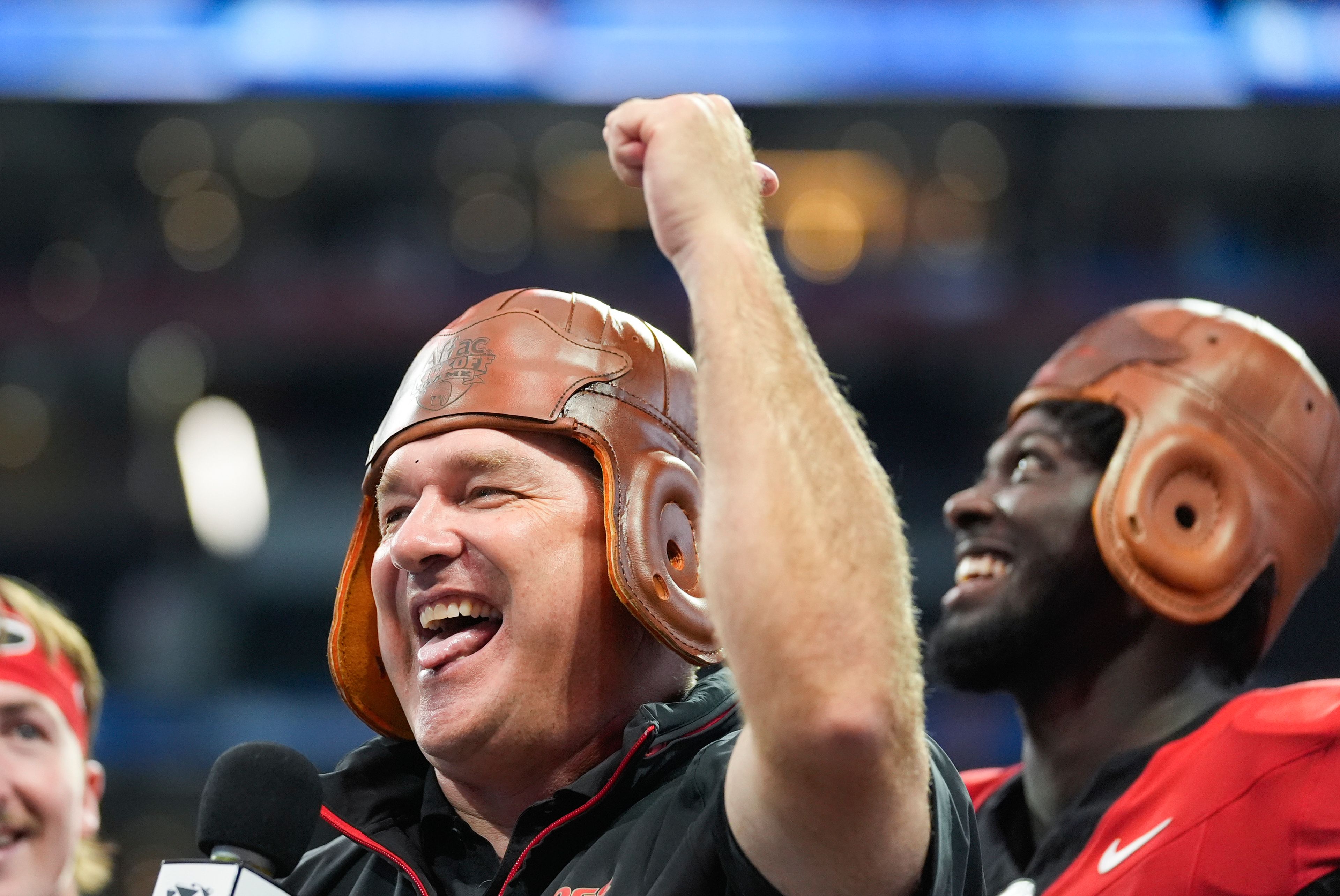 Georgia head caoch Kirby Smart wears the Old Leather helmet as he celebrates after defeating Clemson inn the Aflac Kickofff Classic NCAA college football game Aug. 31, 2024, in Atlanta. (AP Photo/John Bazemore)