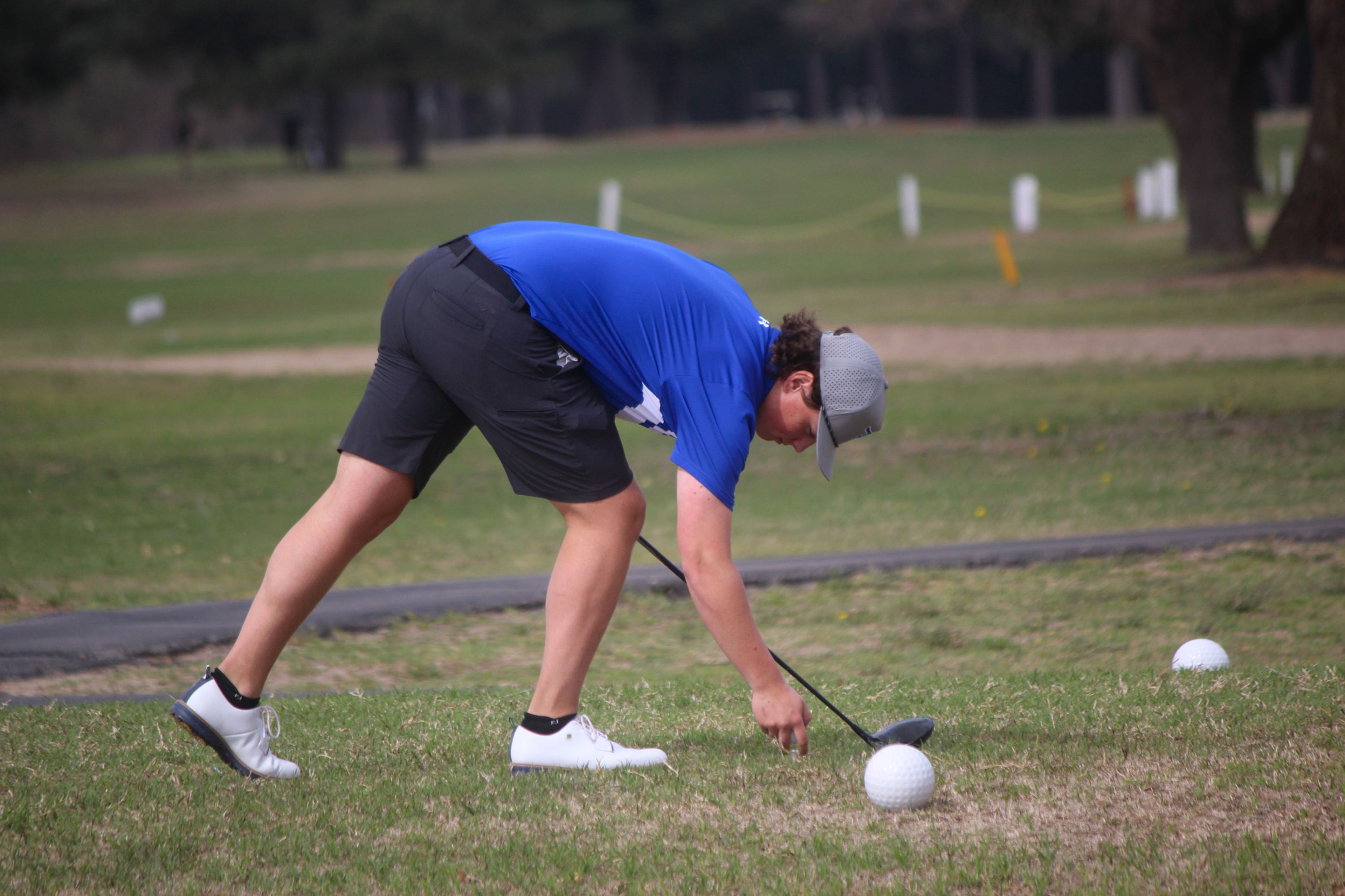 A Twin Rivers golfer places his tee at hole four of Malden's golf course, as the Royal shot 8 under to win the Malden Invitational on Monday, March 31.