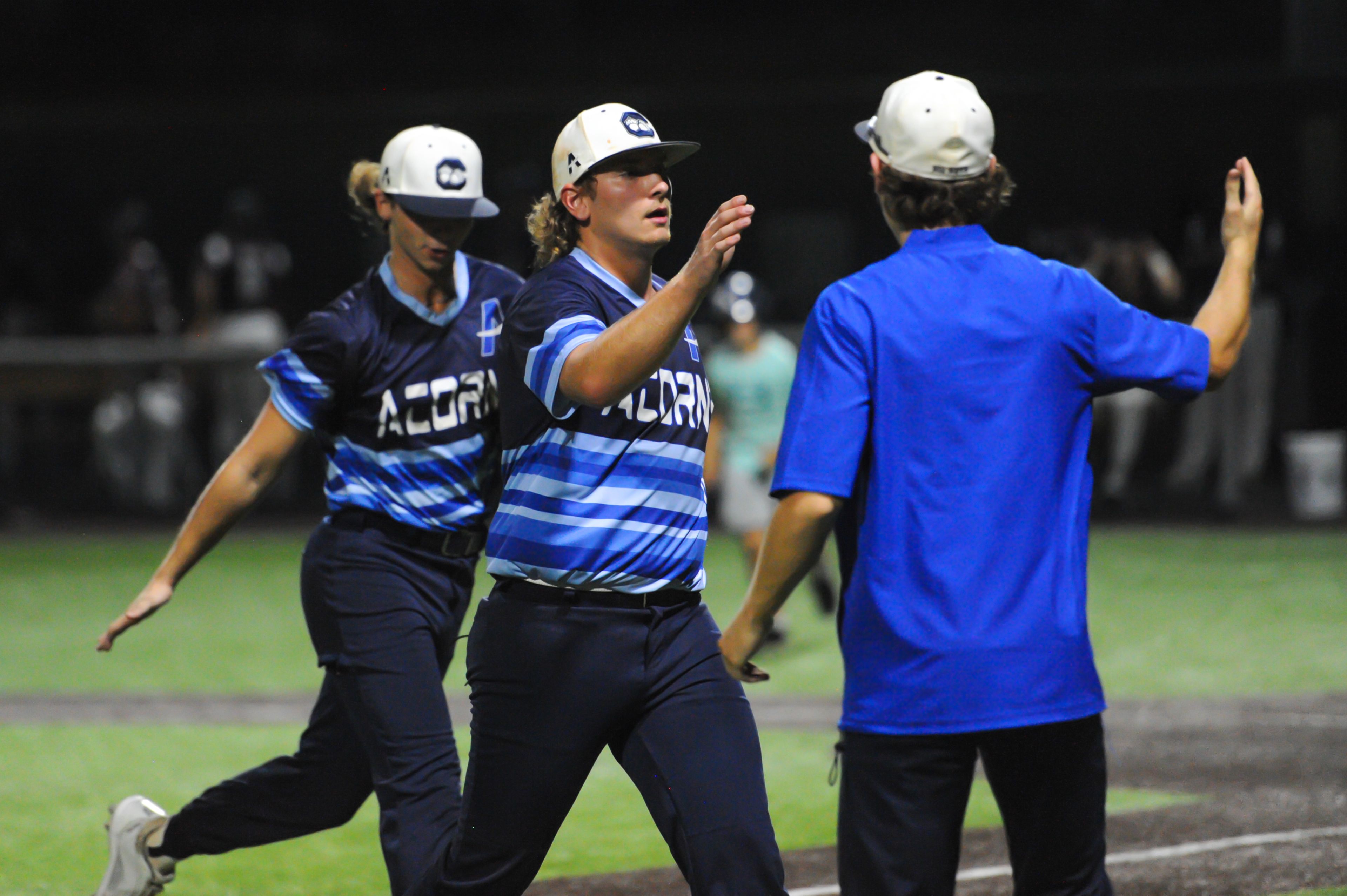 Aycorp's Talan McDaniel (center) is greeted by teammates between innings during an August 14, 2024 Babe Ruth World Series game between the Aycorp Fighting Squirrels and the Altoona, Pennsylvania, at Capaha Field in Cape Girardeau, Mo. Aycorp defeated Altoona, 12-11.