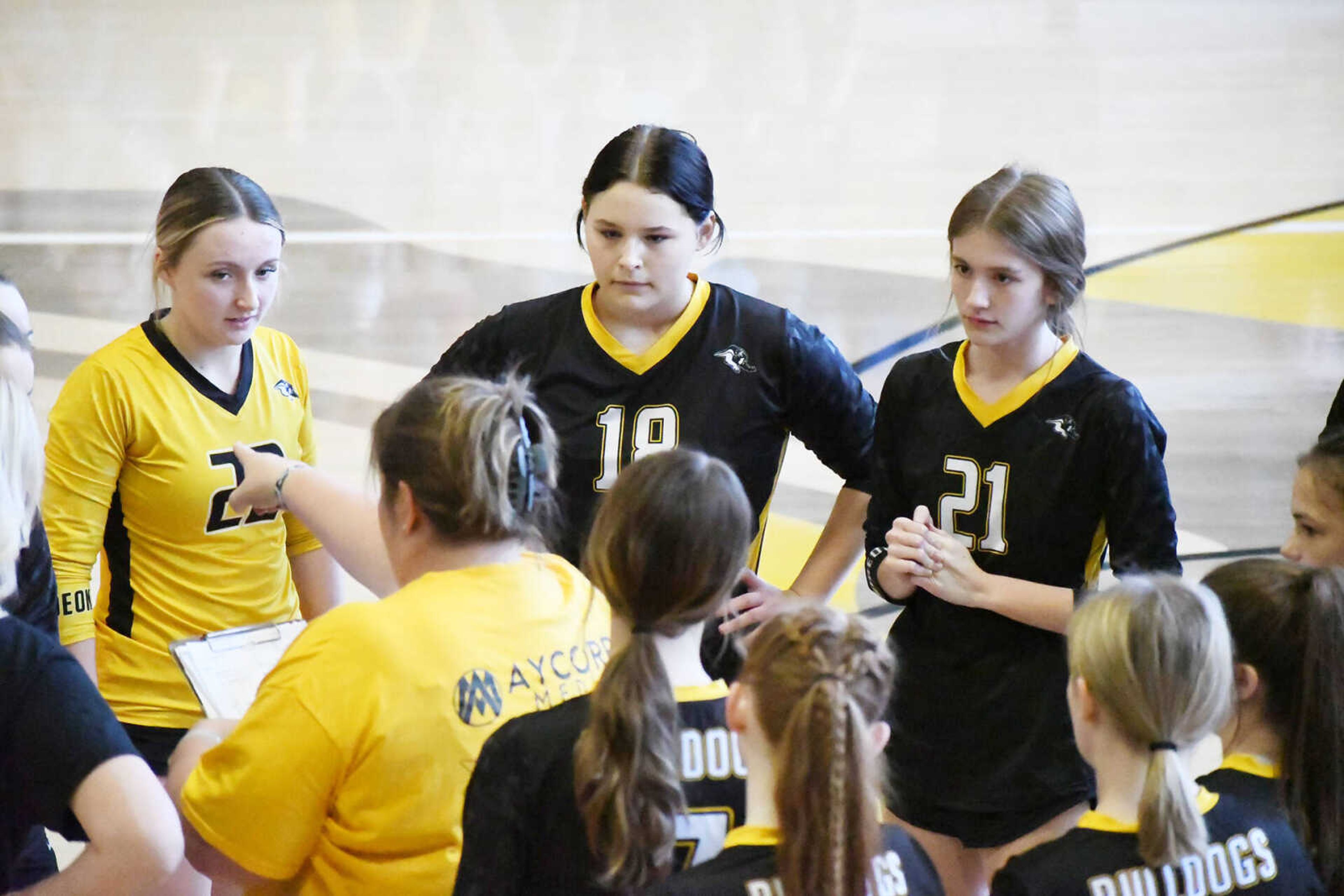 Gideon's Mady Clenney, Lexus Muller and Aubree Sharp listen as head coach Kristen Ashabranner provides instructions before a Class 1 District 2 semifinal versus Bernie dated Saturday, Oct. 21, 2023.