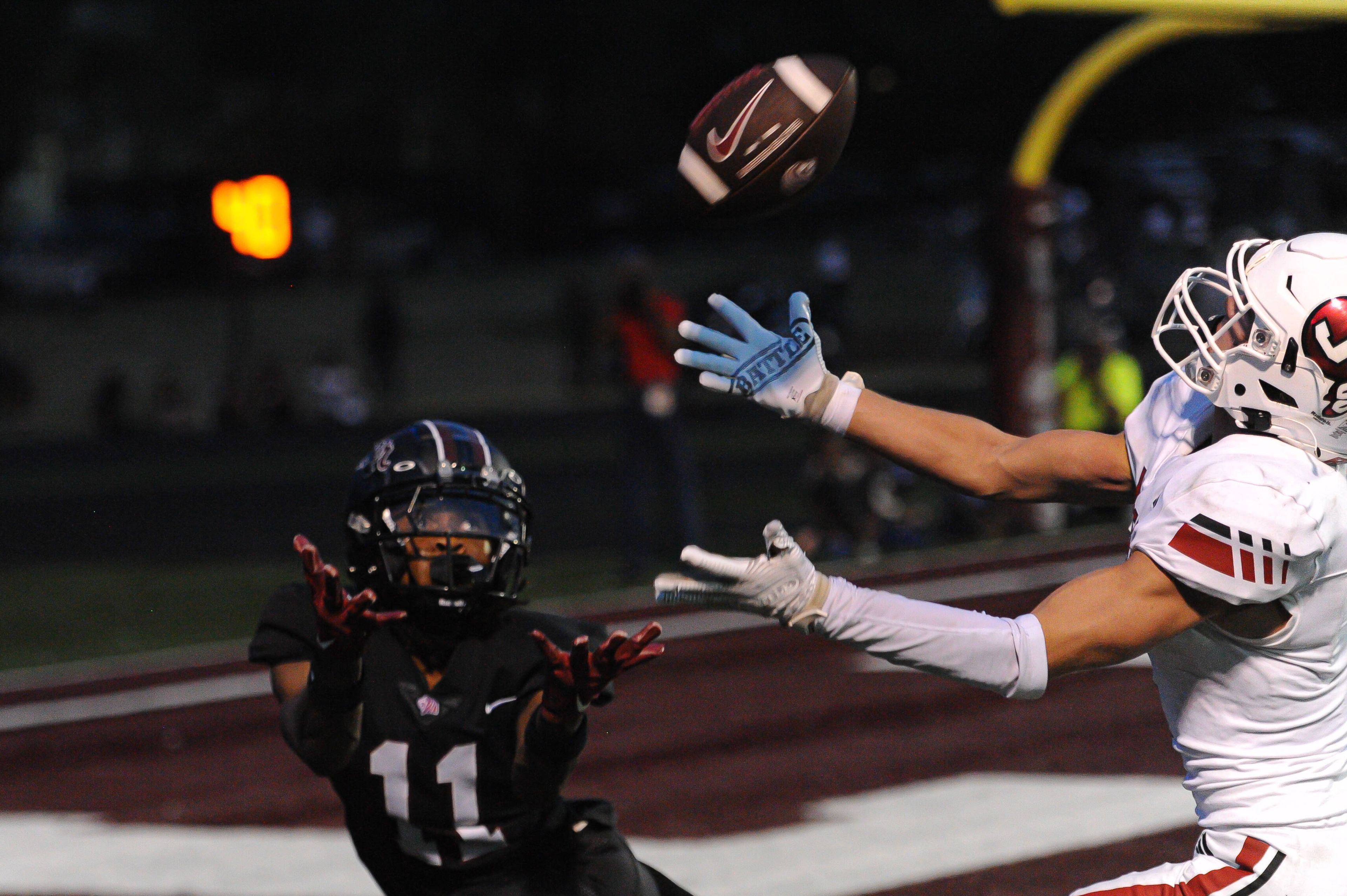 Jackson's Blayne Reagan (right) deflects a pass in the end zone during a Friday, August 30, 2024 game between the Cardinal Ritter College Prep Lions and the Jackson Indians at Cardinal Ritter College Prep High School in St. Louis. Cardinal Ritter defeated Jackson, 44-7.