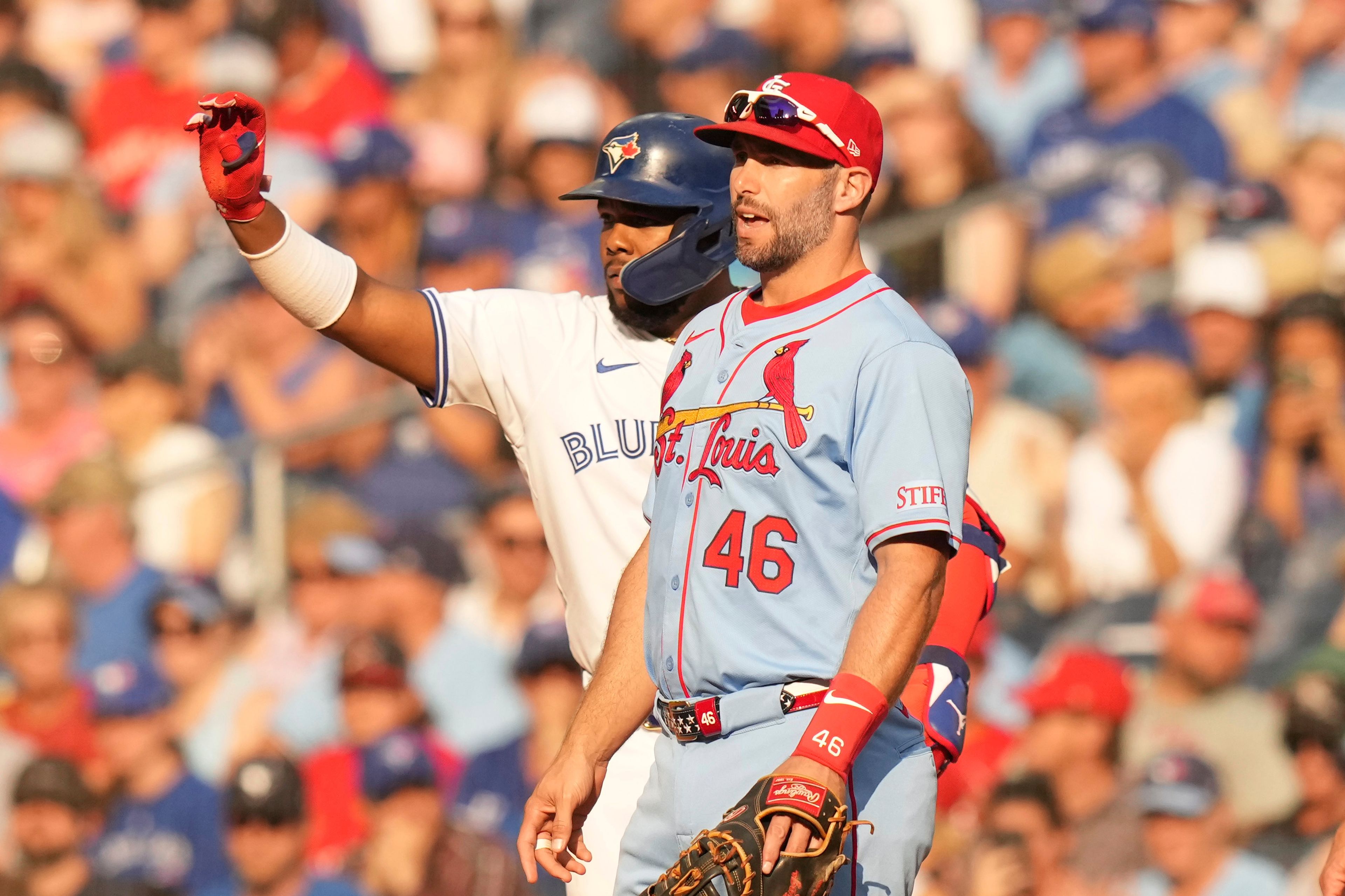 Toronto Blue Jays' Vladimir Guerrero Jr. gestures for the ball after hitting an RBI single, his 500th RBI as a Blue Jay, as he stands with St. Louis Cardinals first baseman Paul Goldschmidt during seventh inning interleague MLB baseball action in Toronto, Saturday, September 14, 2024. (Chris Young/The Canadian Press via AP)