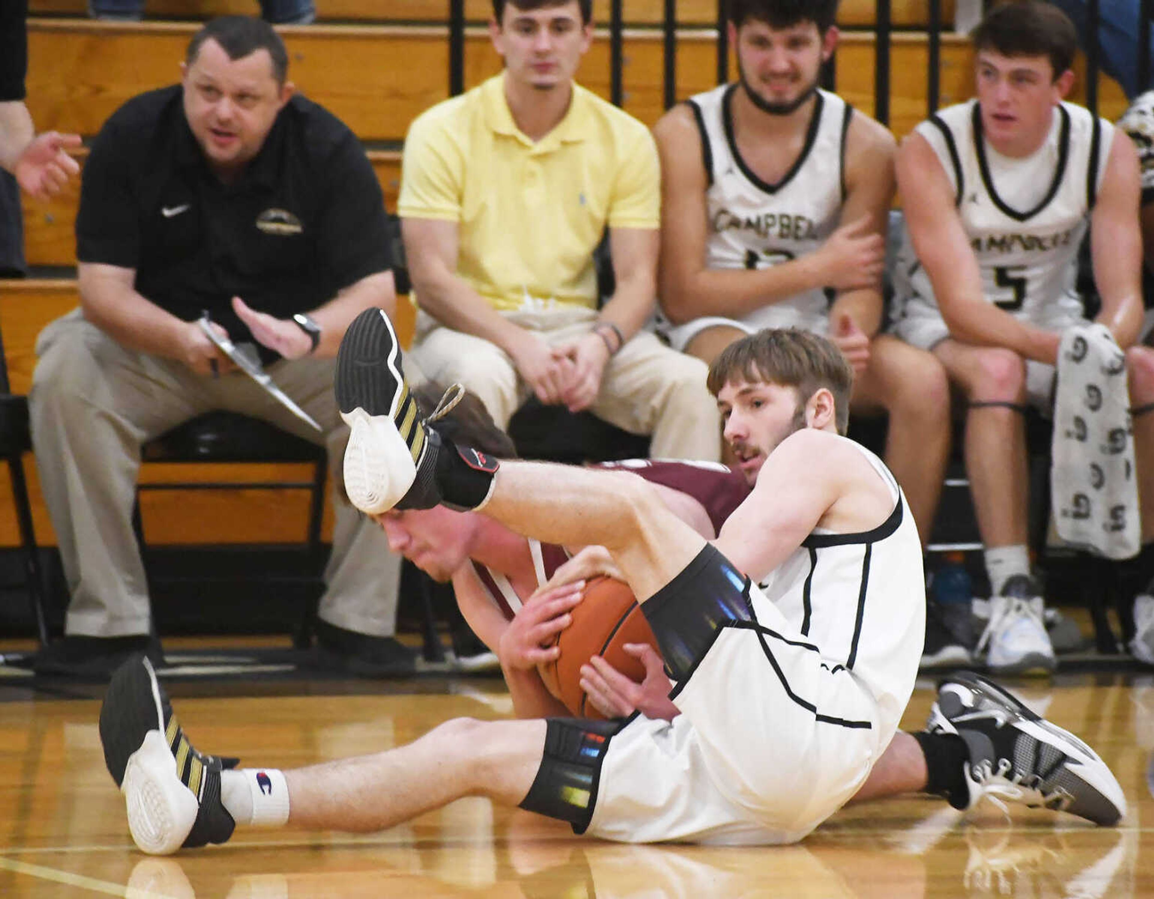 Campbell’s Jackson Anthony (white jersey) forces a jump ball by tying up an unidentifiable player from St. Paul Lutheran during a jamboree dated Thursday, Nov. 16, 2023.