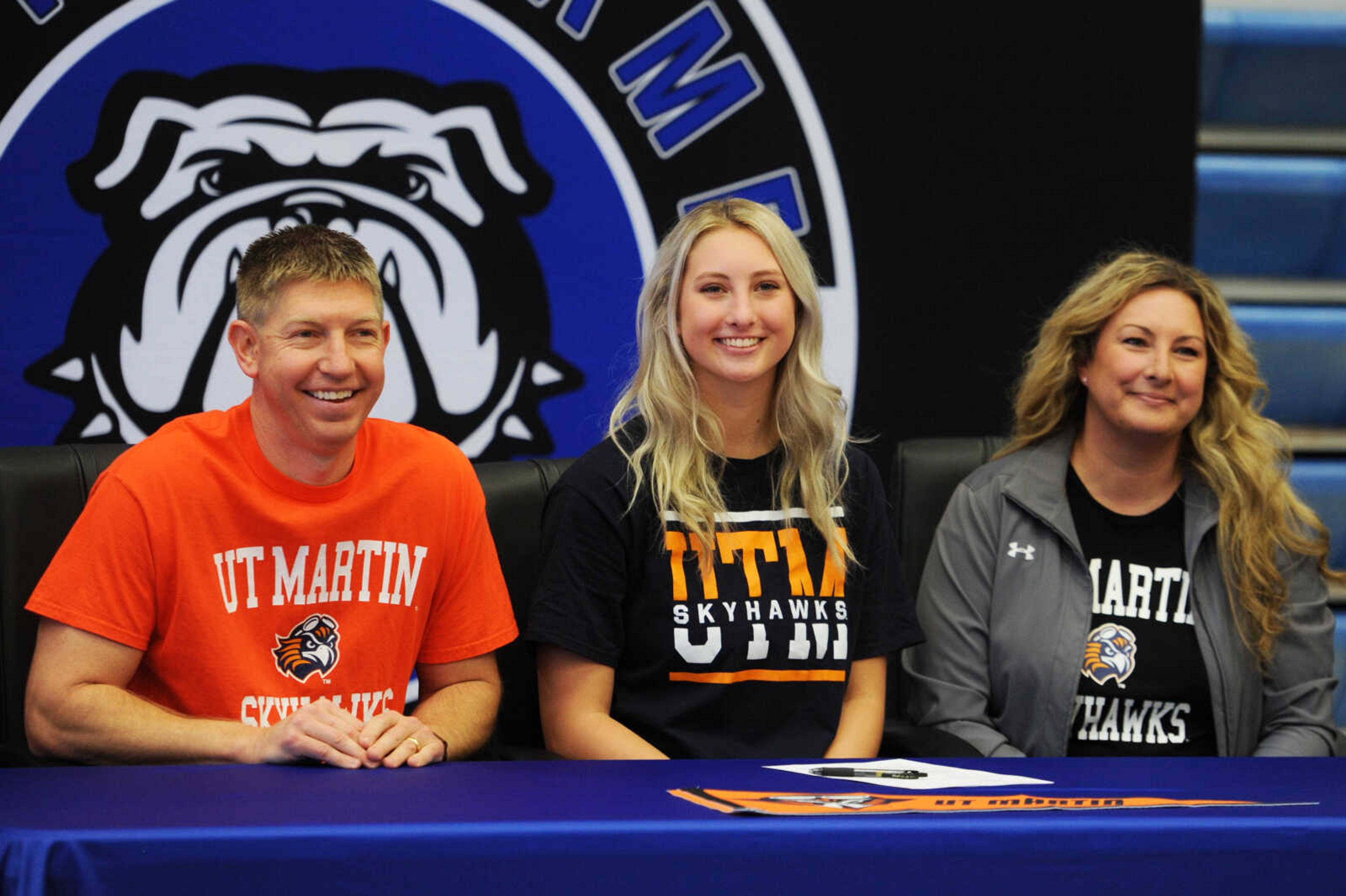 Notre Dame senior Tori Rubel, middle, poses for a photo with her father Matt, left, and mother Michele, right, after signing a National Letter of Intent to continue her basketball career with UT-Martin on Wednesday at Notre Dame Regional High School.