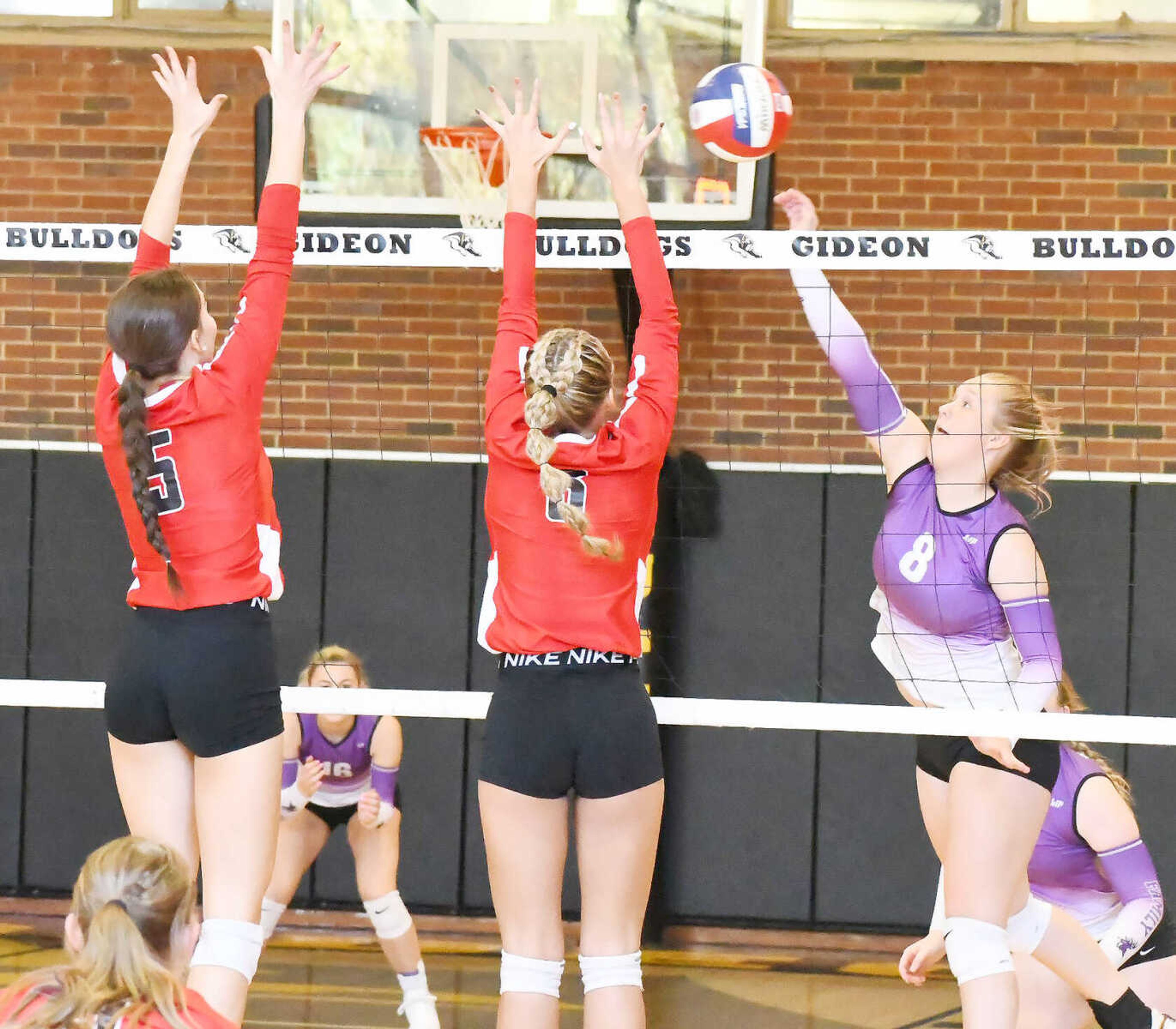 Clarkton's Angel Johnson (right) attempts to go for the kill while Elaina Bowling (5) and Maddie Asher (6) of Bell City put up the block during a Class 1 District 2 semifinal match dated Saturday, Oct. 21, 2023.