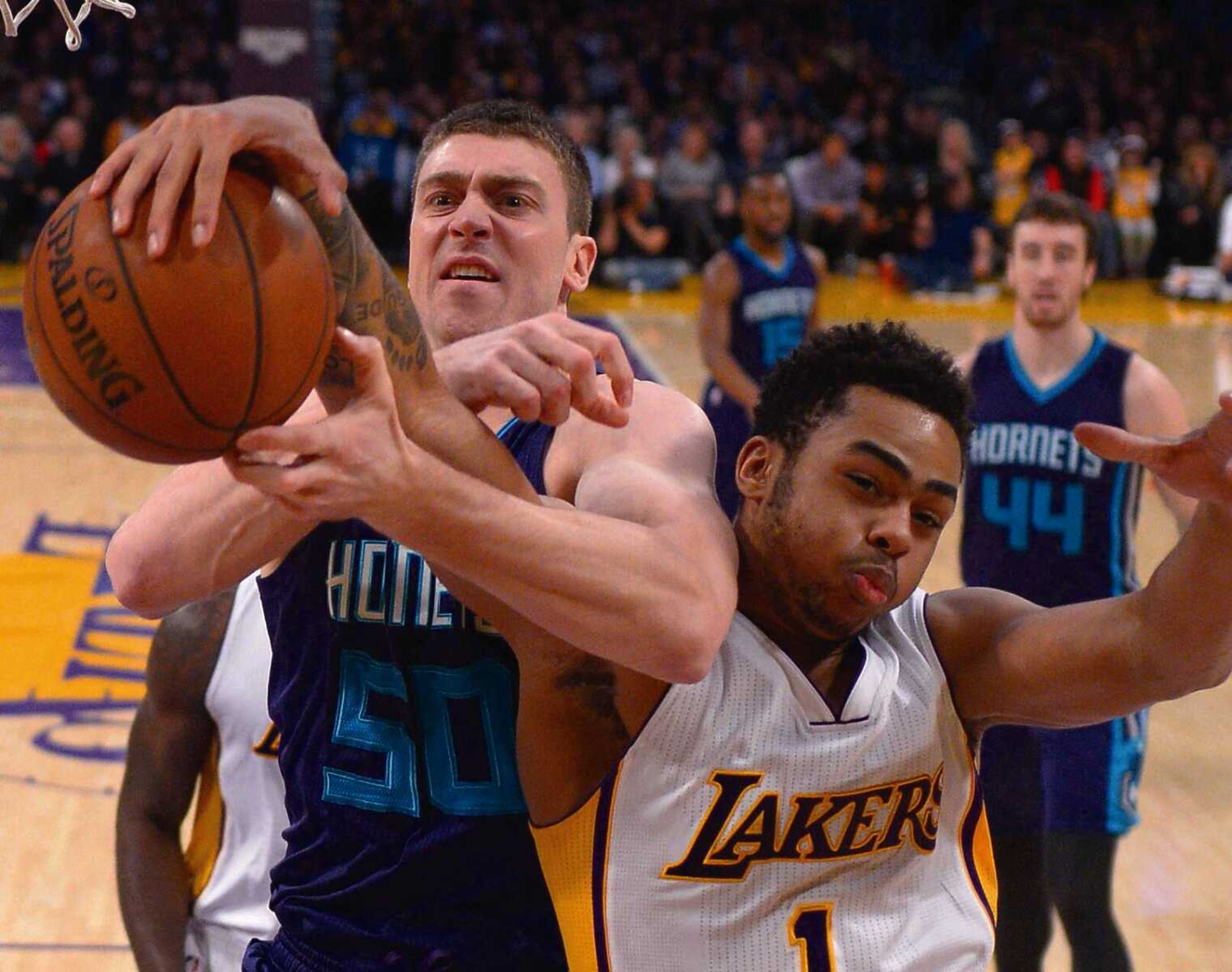 Charlotte Hornets forward Tyler Hansbrough, left, and Los Angeles Lakers guard D’Angelo Russell battle for a rebound during Hansbrough’s last season in the NBA in January 2016 in Los Angeles, Calif. Hansbrough now lives in North Carolina and also dabbles in sports media with his own podcast while he figures out what life after basketball looks like.