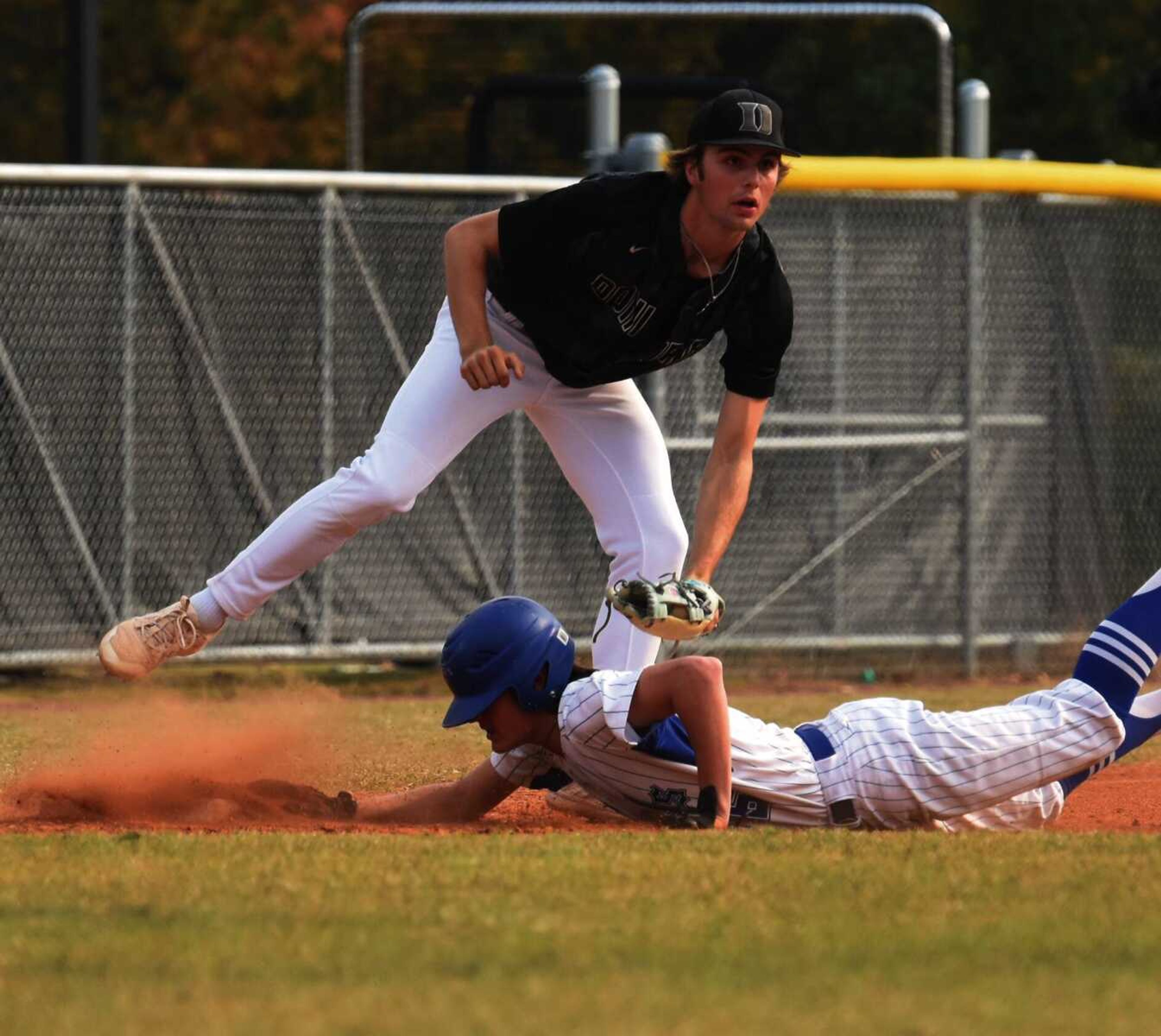 Doniphan third baseman Emmitt Jones awaits the umpire's decision after applying the tag to Twin Rivers' Jake Hester during the semifinal round of the OFC Tournament on Tuesday, Oct. 11, 2022 in Poplar Bluff.