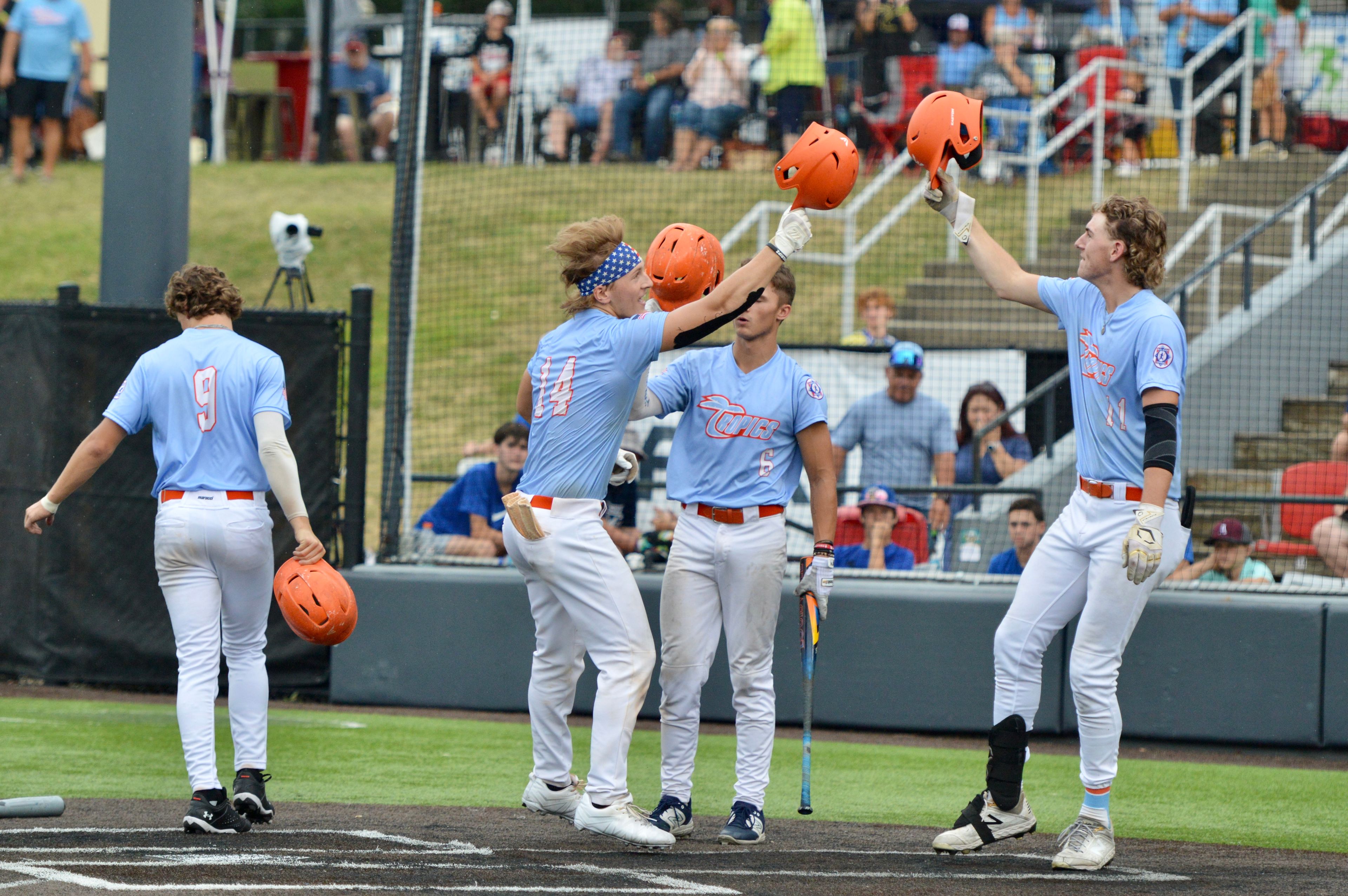 Southeast Tropics catcher Trey Benthal celebrates with his teammates after hitting a home run on Wednesday against Puerto Rico at Capaha Field.