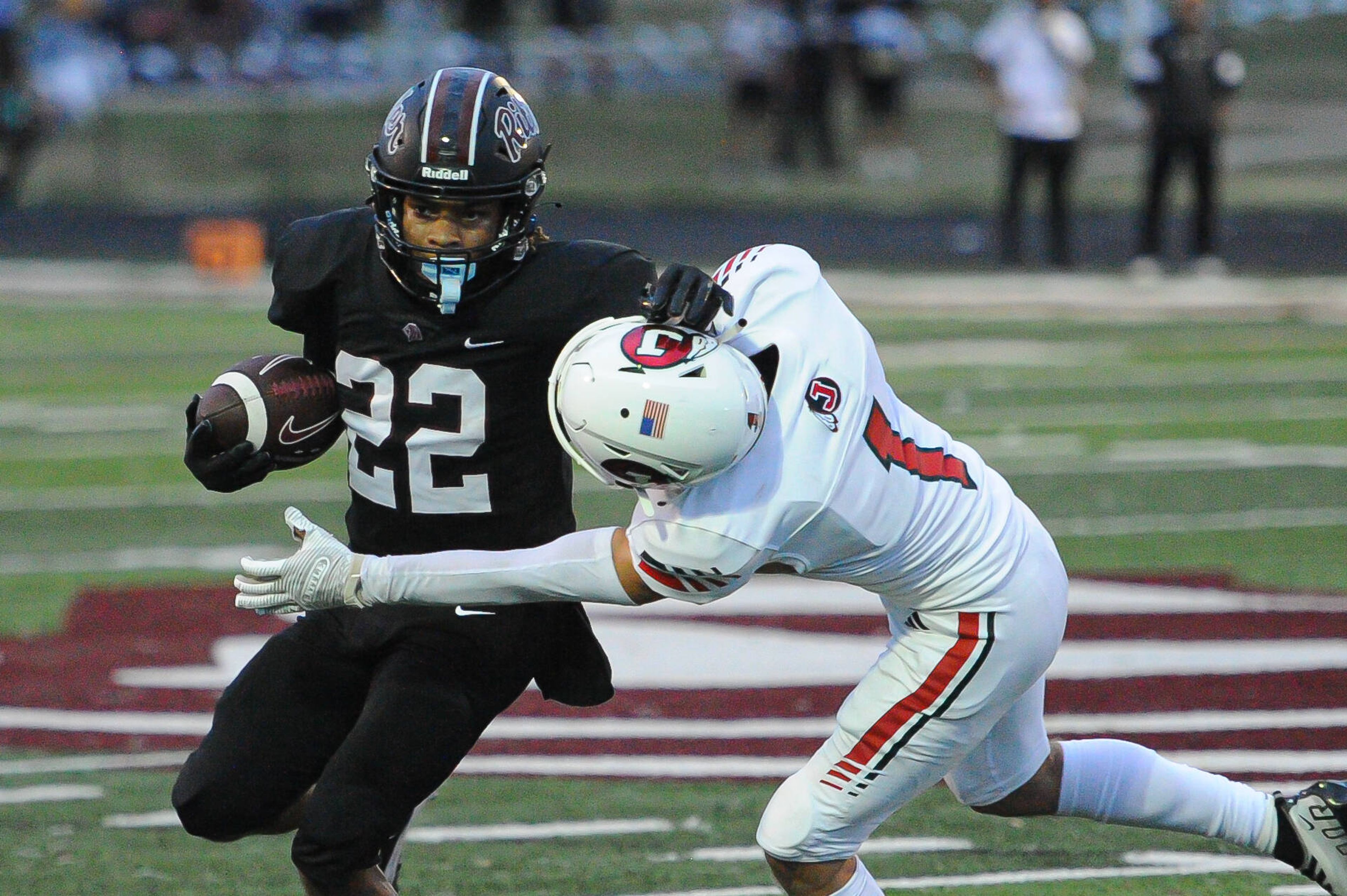 Cardinal Ritter's Manny Ellis fights through a tackle during a Friday, August 30, 2024 game between the Cardinal Ritter College Prep Lions and the Jackson Indians at Cardinal Ritter College Prep High School in St. Louis. Cardinal Ritter defeated Jackson, 44-7.