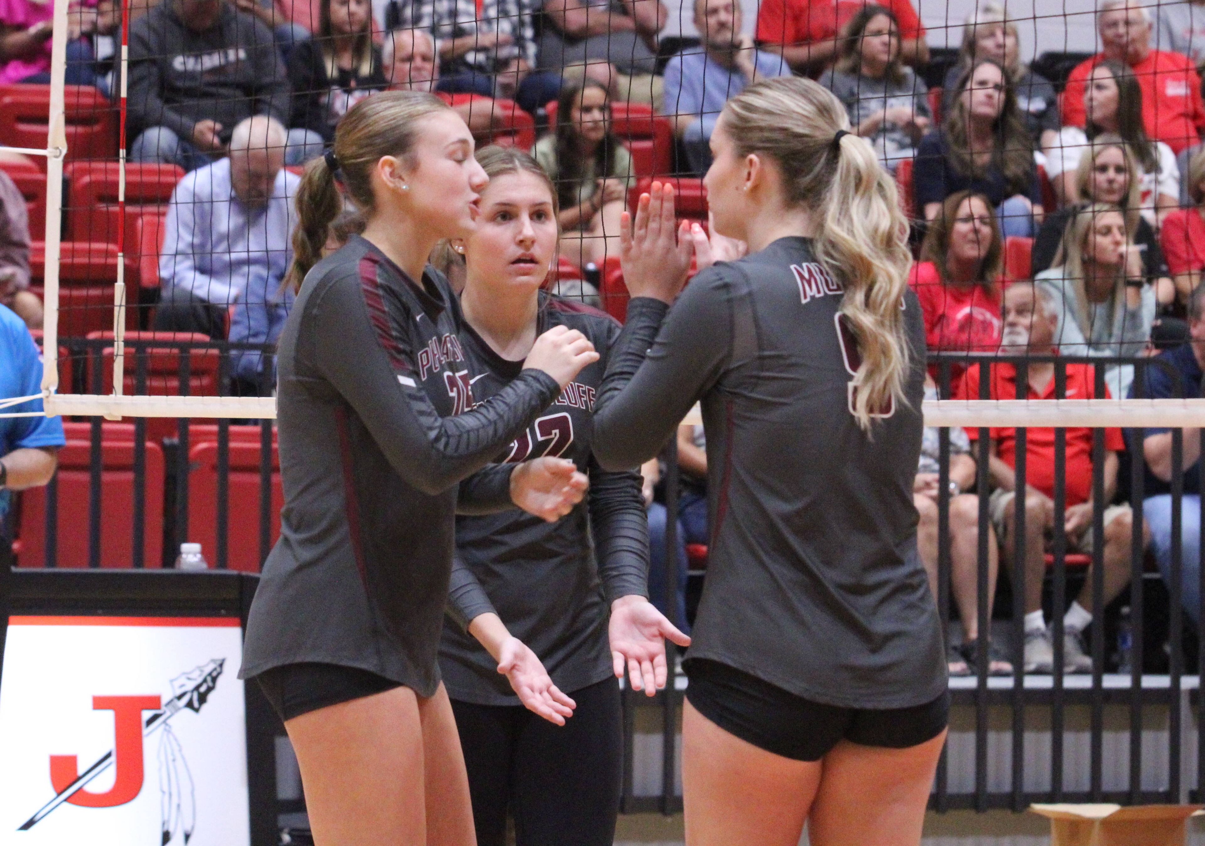 Poplar Bluff's Chloe Parkin (left), Presley Tinsley (middle) and Bailey Henson (right) talk before a play during the Tuesday, September 10 match between Jackson and Poplar Bluff at Jackson High School in Jackson, Mo. 