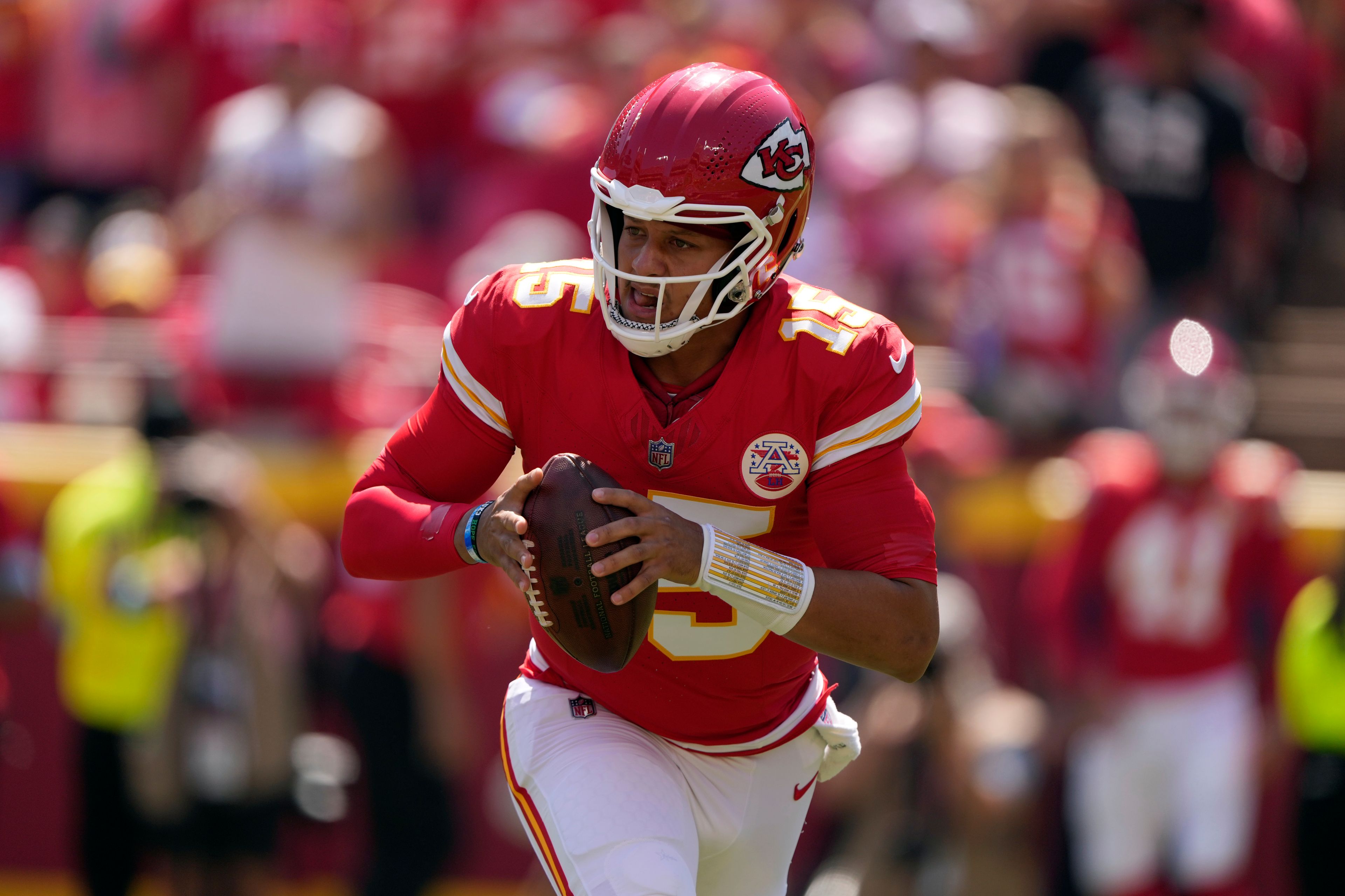 Kansas City Chiefs quarterback Patrick Mahomes (15) rolls out to pass against the Detroit Lions during the first half of an NFL preseason football game Saturday, Aug. 17, 2024, in Kansas City, Mo. (AP Photo/Charlie Riedel)