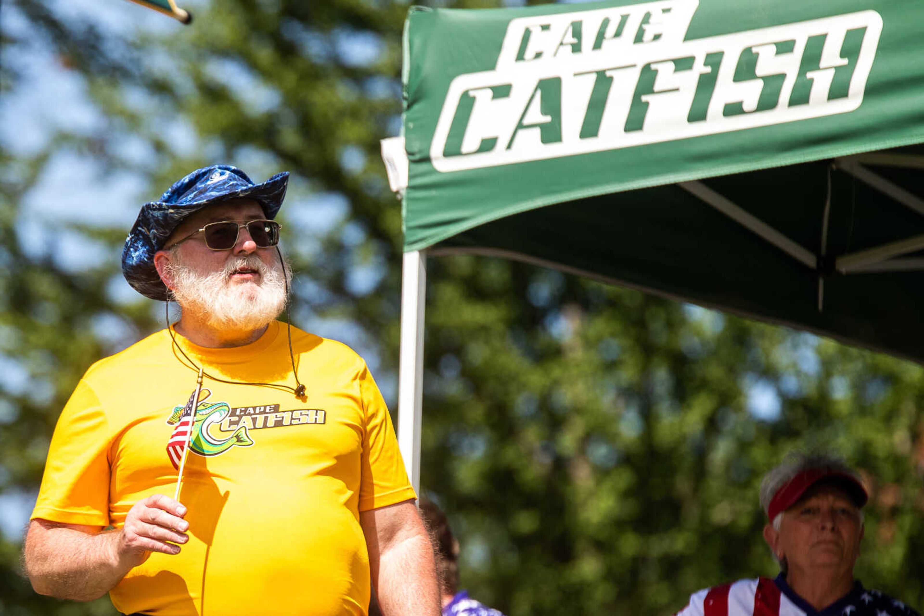 Philip Crawford, whose son just left for a tour in Kuwait with the Army, waves a small American flag on Flag Day at Capaha Field.