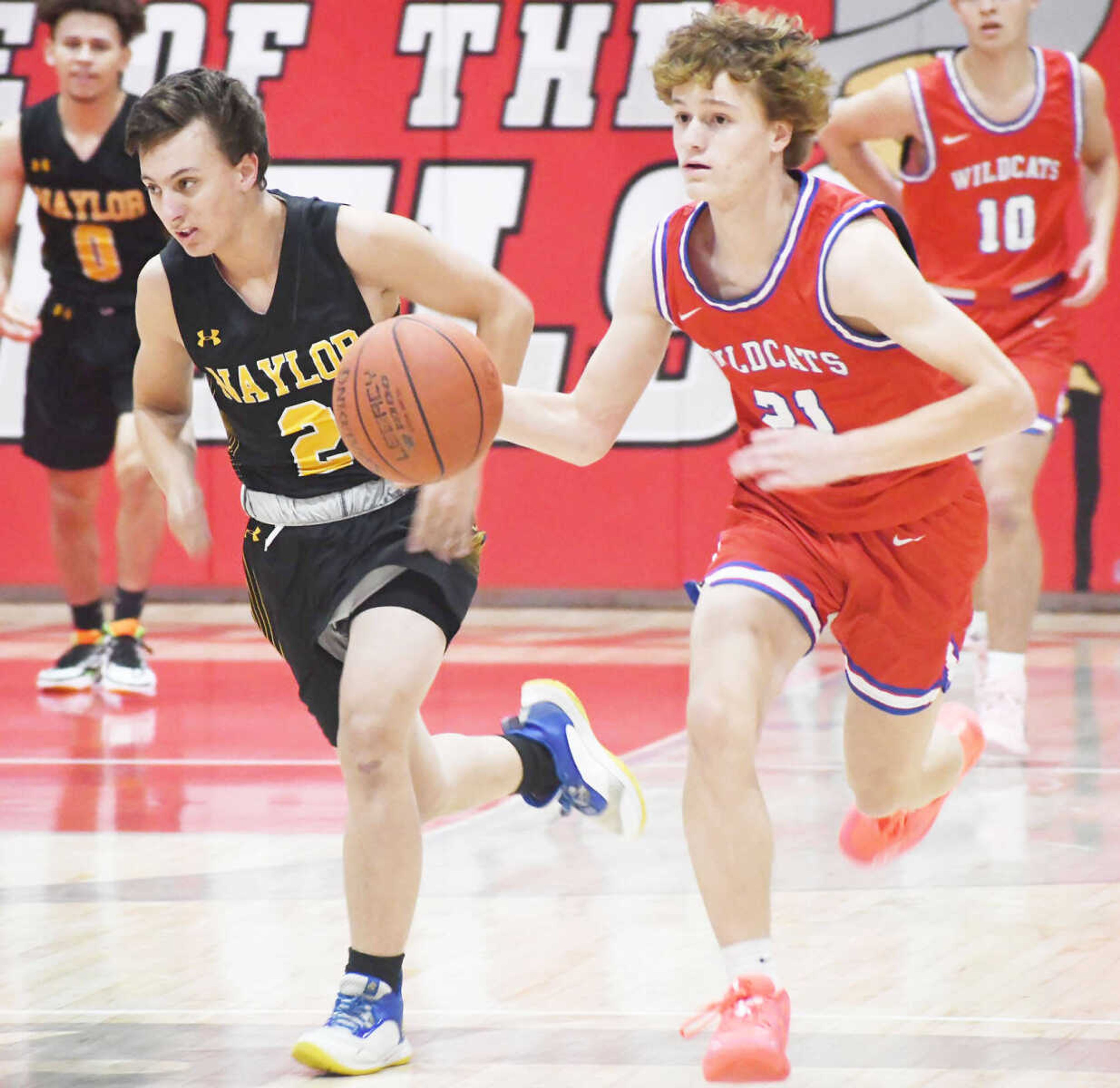 Cooter’s Jayden Mclevain (21) dribbles on the fastbreak while defended by Naylor’s Joseph Bunn (2) on Tuesday, Nov. 14, 2023, in Cardwell.