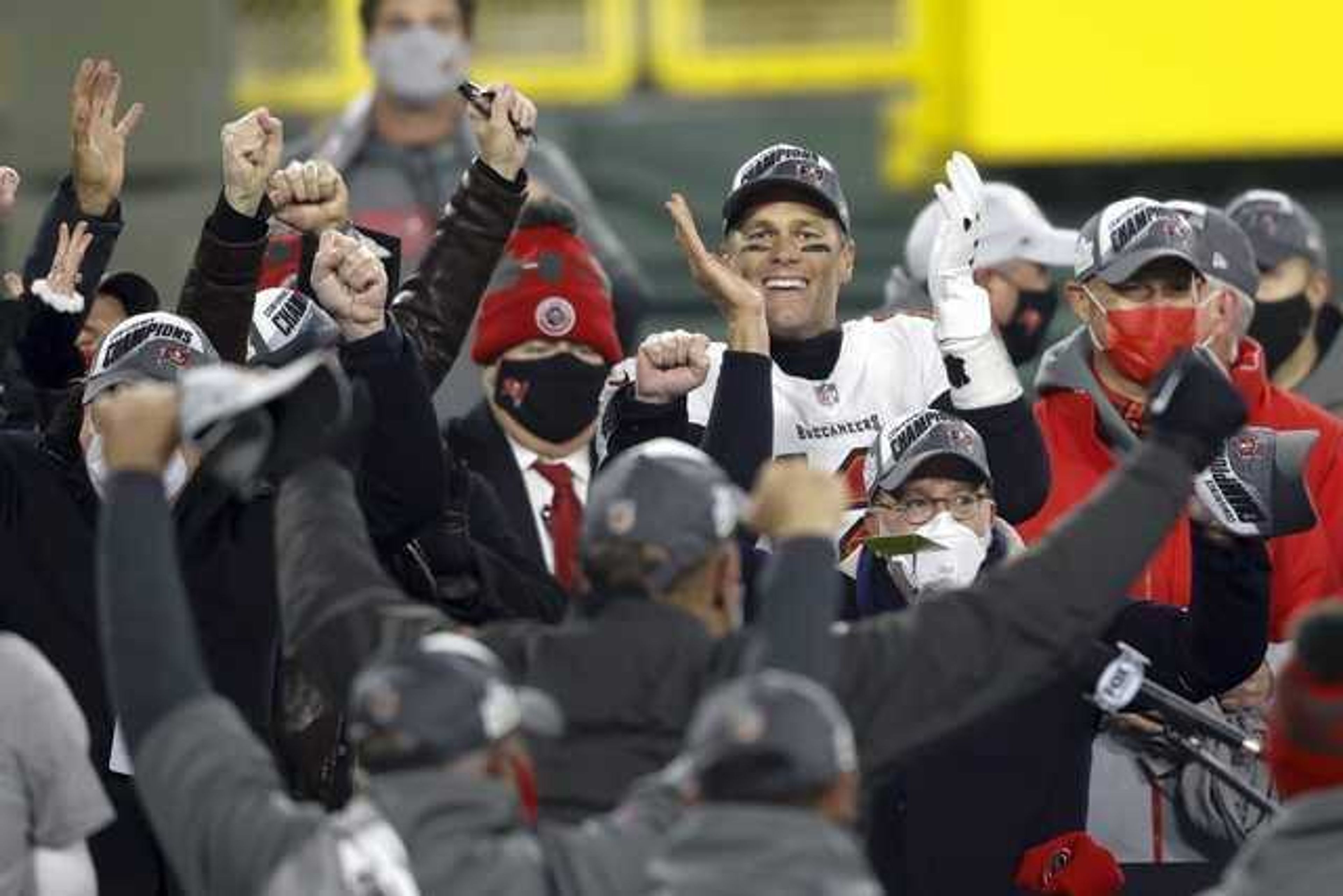 Tampa Bay Buccaneers quarterback Tom Brady celebrates with his teammates after winning the NFC championship game against the Green Bay Packers in Green Bay, Wis., Sunday.