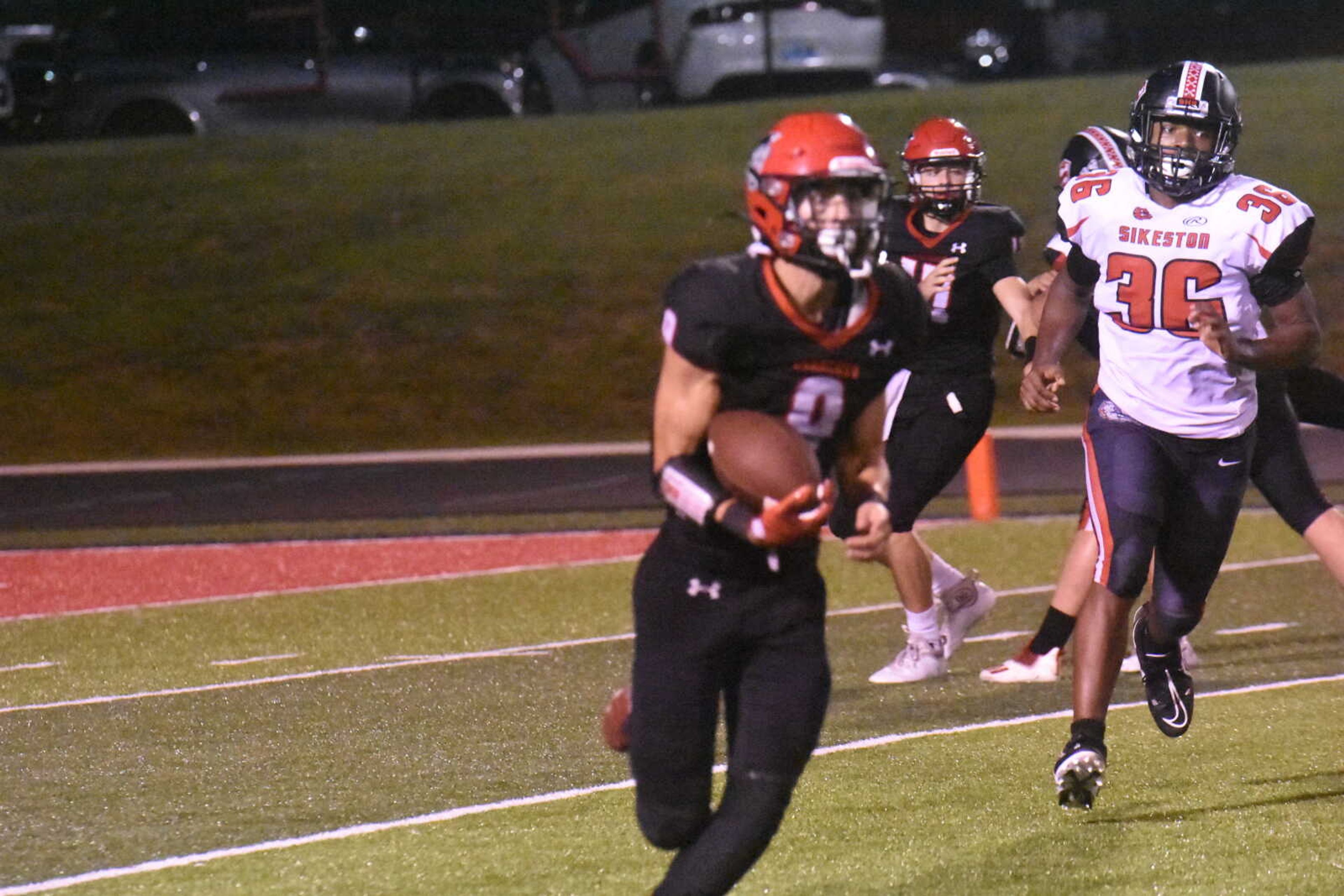 Dexter's RJ Farmer (9) runs around end against Sikeston Friday night.