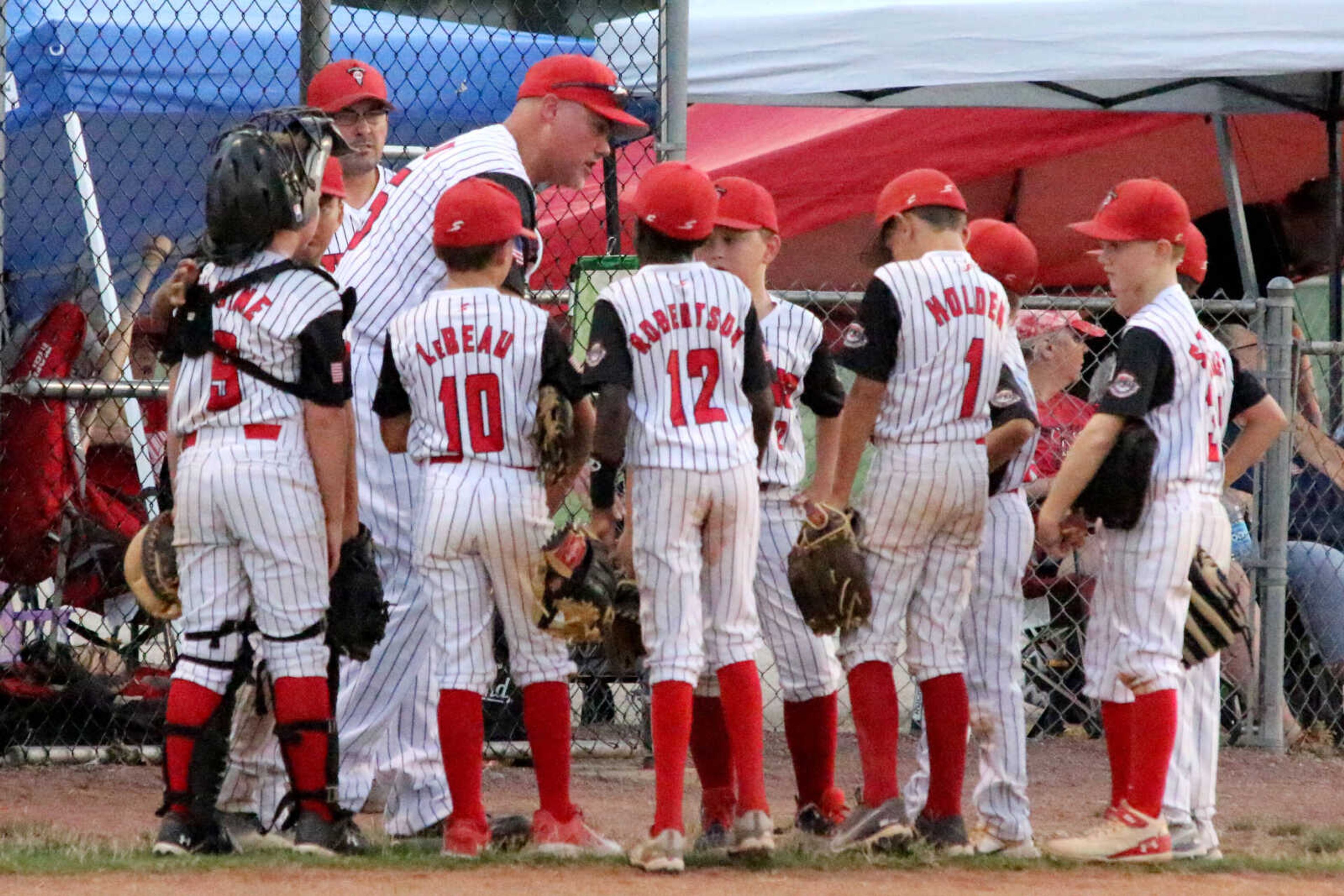 Dexter Titans’ coach Clint LeBeau offers some words of encouragement to his team during the 2023 Cal Ripken Midwest Plains Regional Tournament at the Sikeston Sports Complex on Thursday, July 27. (Dennis Marshall/Standard-Democrat)