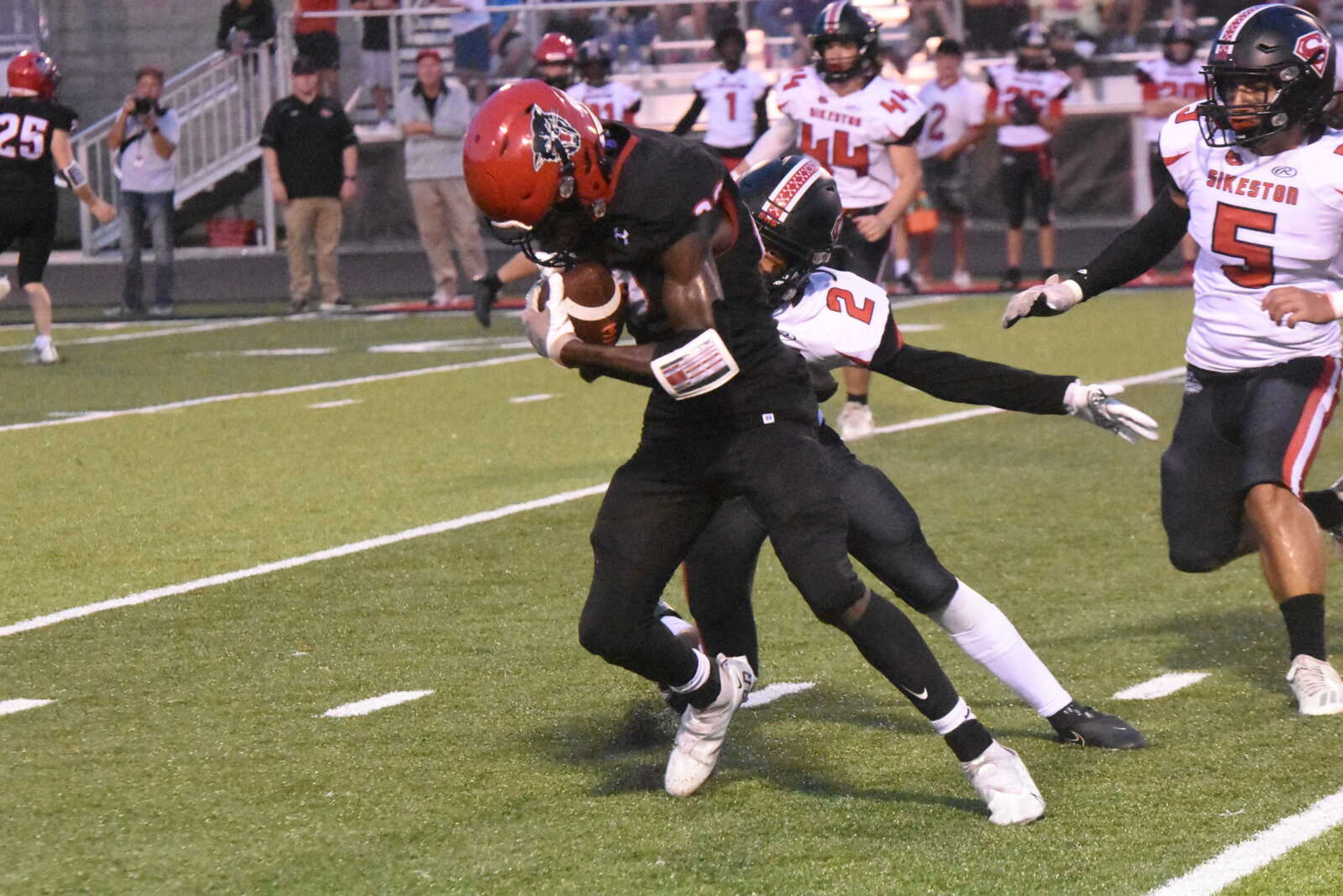 Dexter's Jaxen Grams pulls away from a Sikeston defender after hauling in a pass.